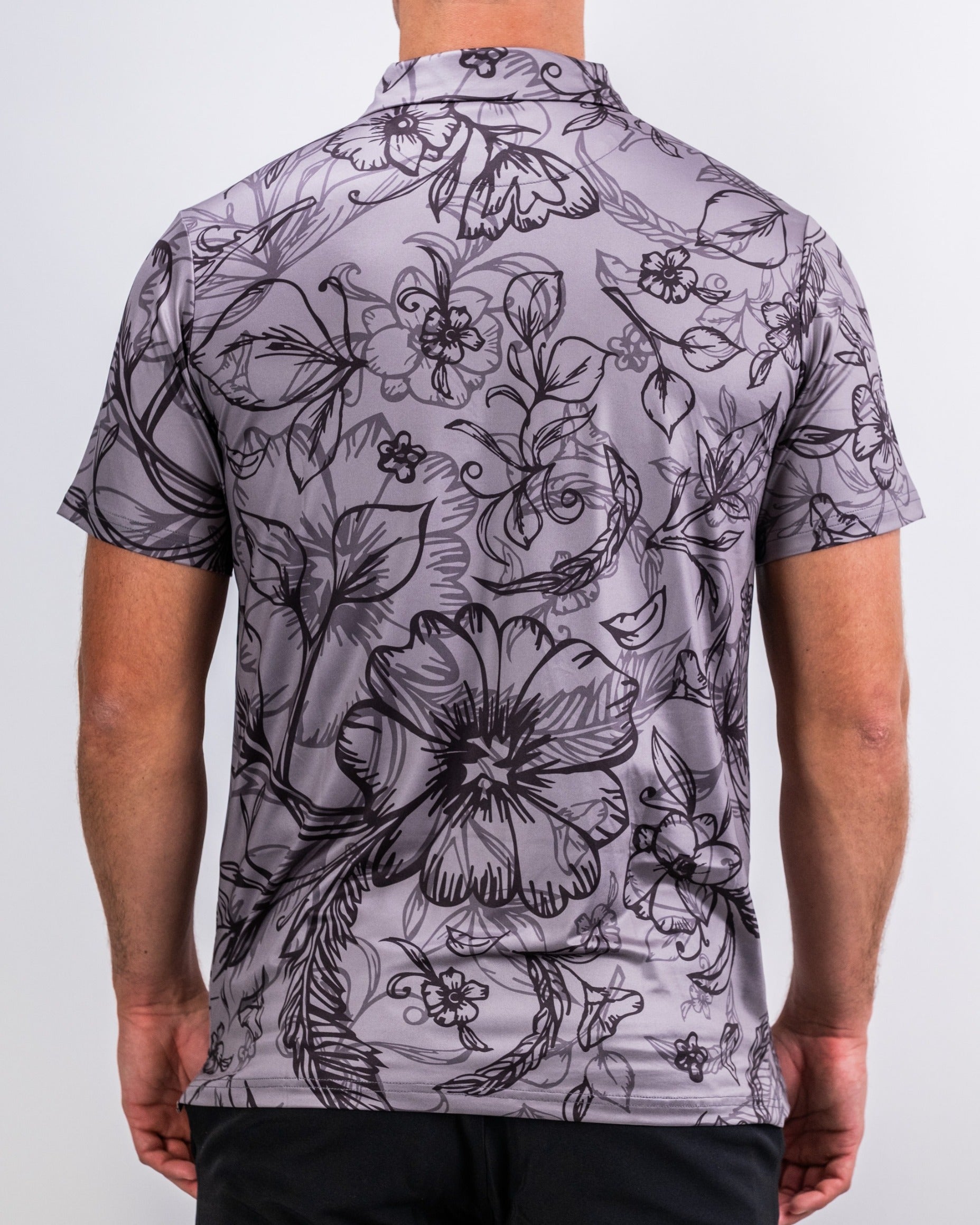 Men's short-sleeve golf shirt featuring a stylish floral pattern in shades of gray, designed for a bold look on the course.