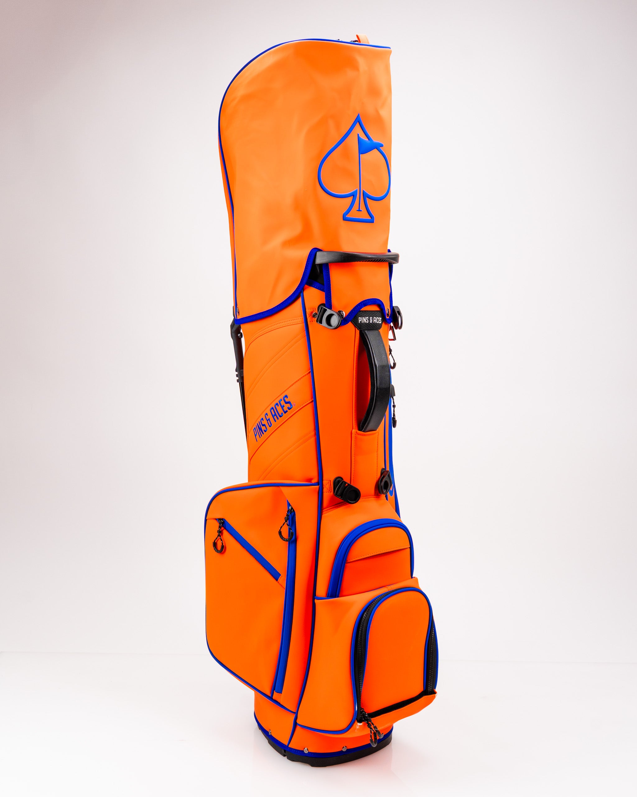 Bold orange golf bag with blue accents, featuring multiple pockets and a sleek design for stylish golfers.
