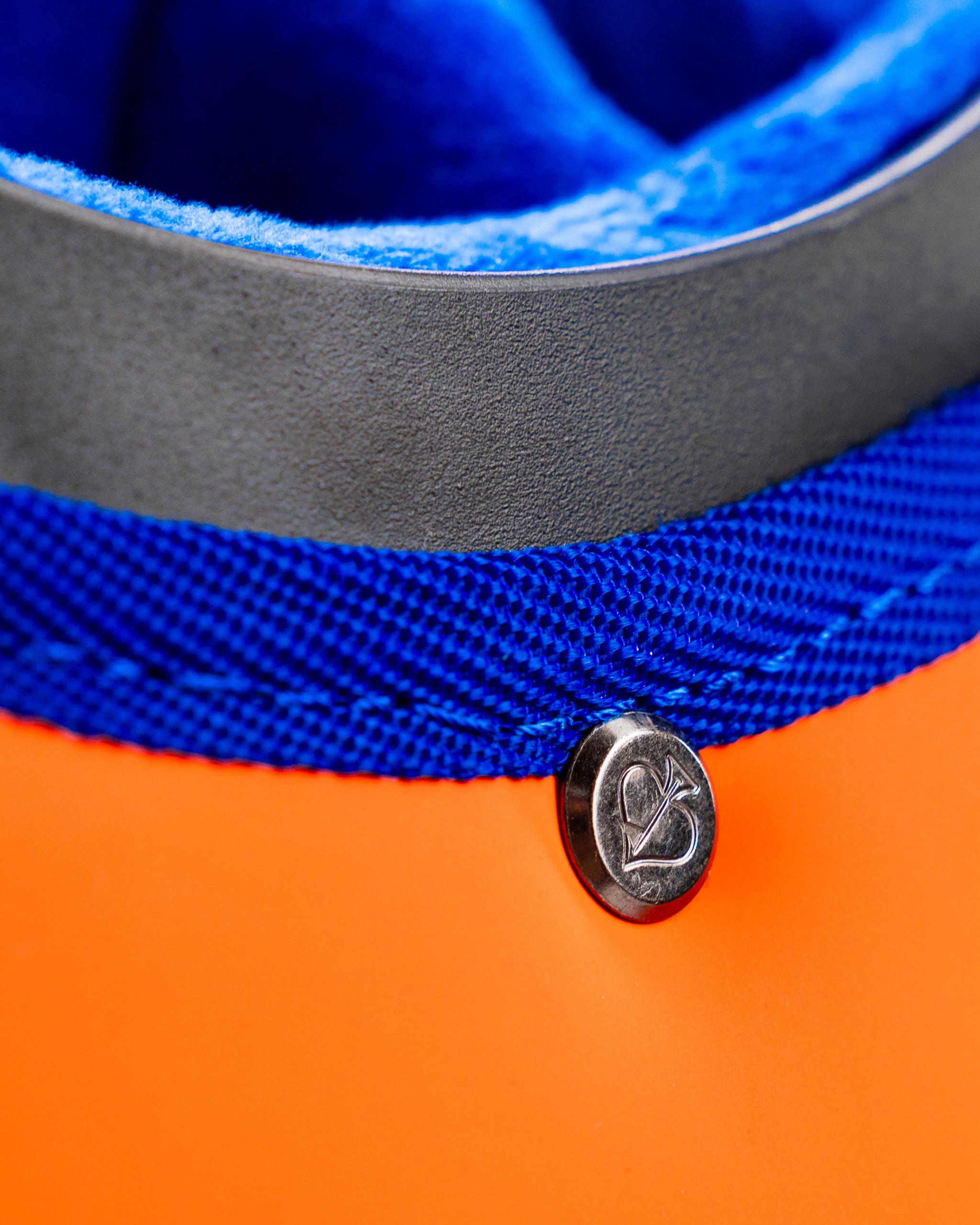 Close-up of the Player Preferred Golf Bag in Orange Crush, showcasing vibrant orange material and blue lining details.