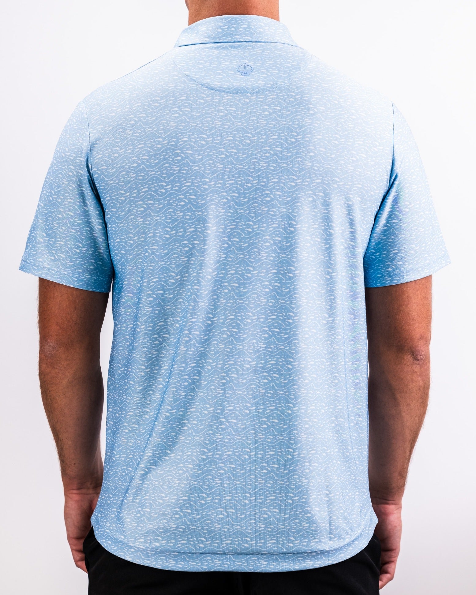 Men's Player Preferred Polo in Tidal Flow design, featuring a light blue color with a subtle wave pattern on the back.