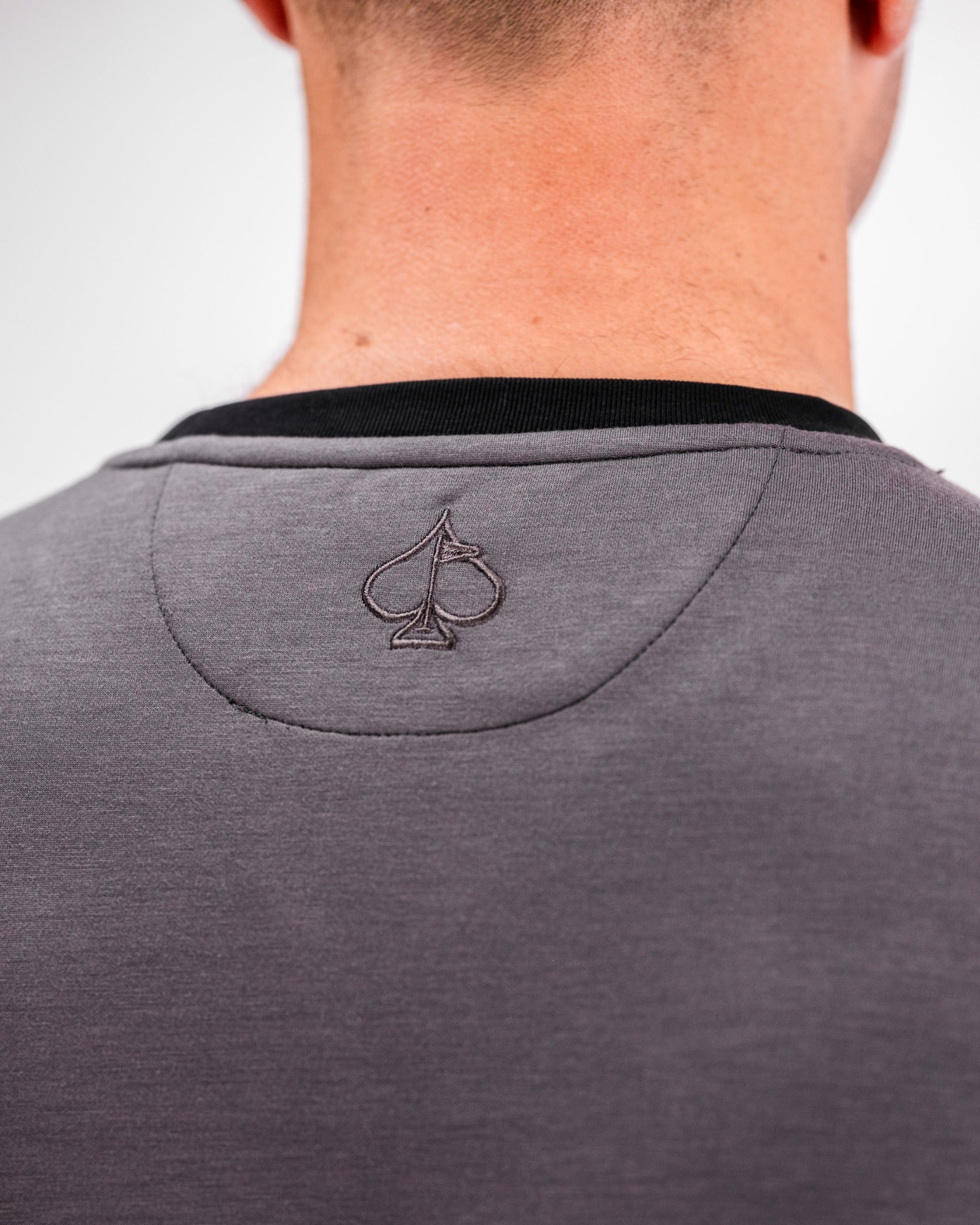 Slate grey crewneck featuring a subtle embroidered logo on the back, designed for stylish comfort on the golf course.