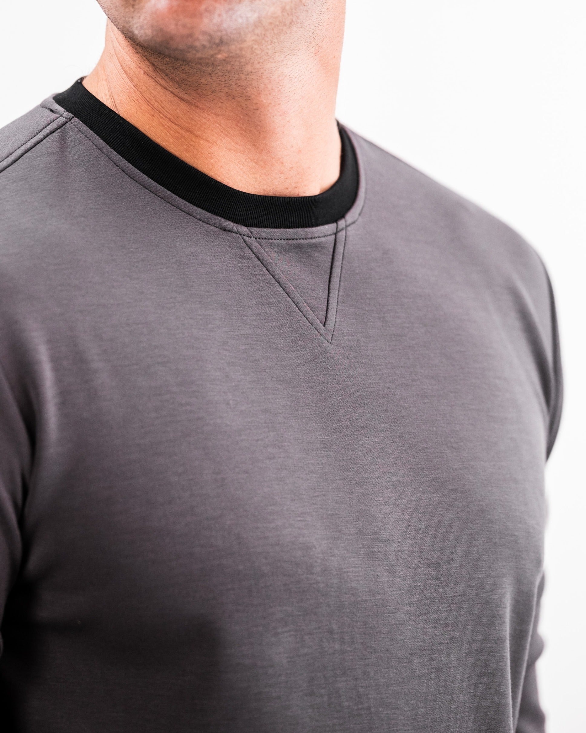 Slate grey crewneck sweatshirt with a black collar, designed for comfort and style on and off the golf course.