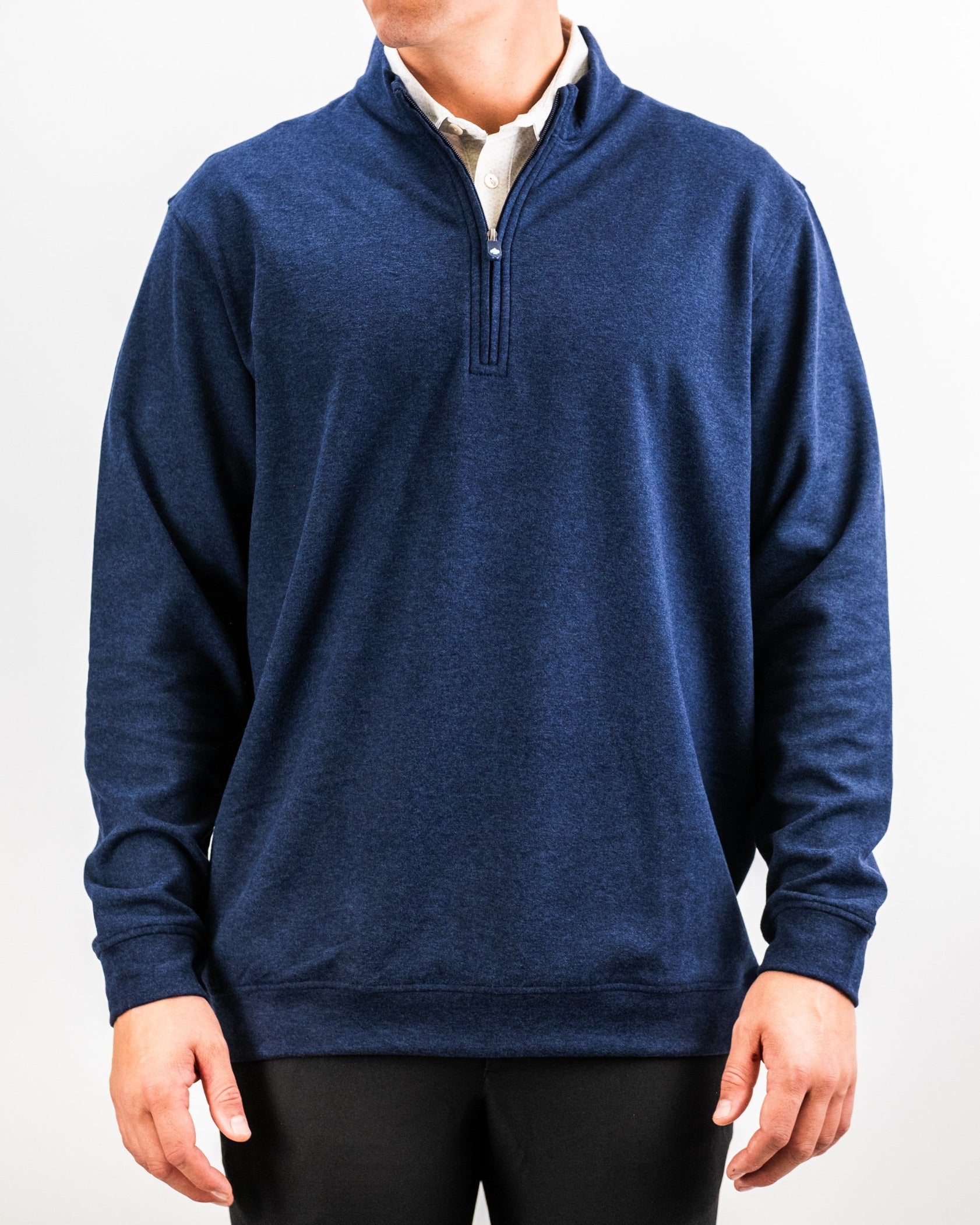 Heathered navy pullover with a quarter zip, designed for comfort and style on the golf course. Perfect for layering.