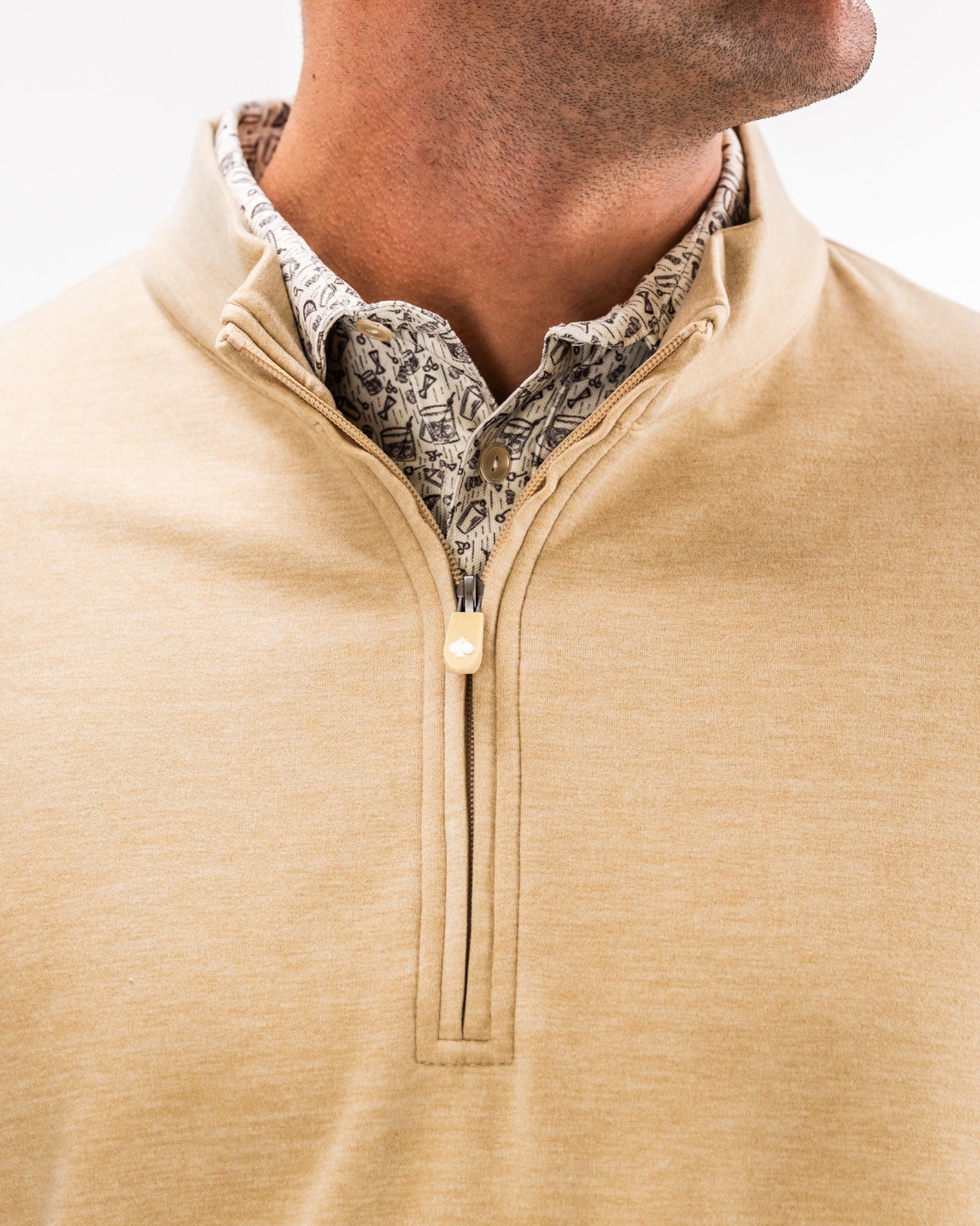Men's Player Preferred Pullover in sand color featuring a half-zip design and stylish patterned collar for a bold golf look.