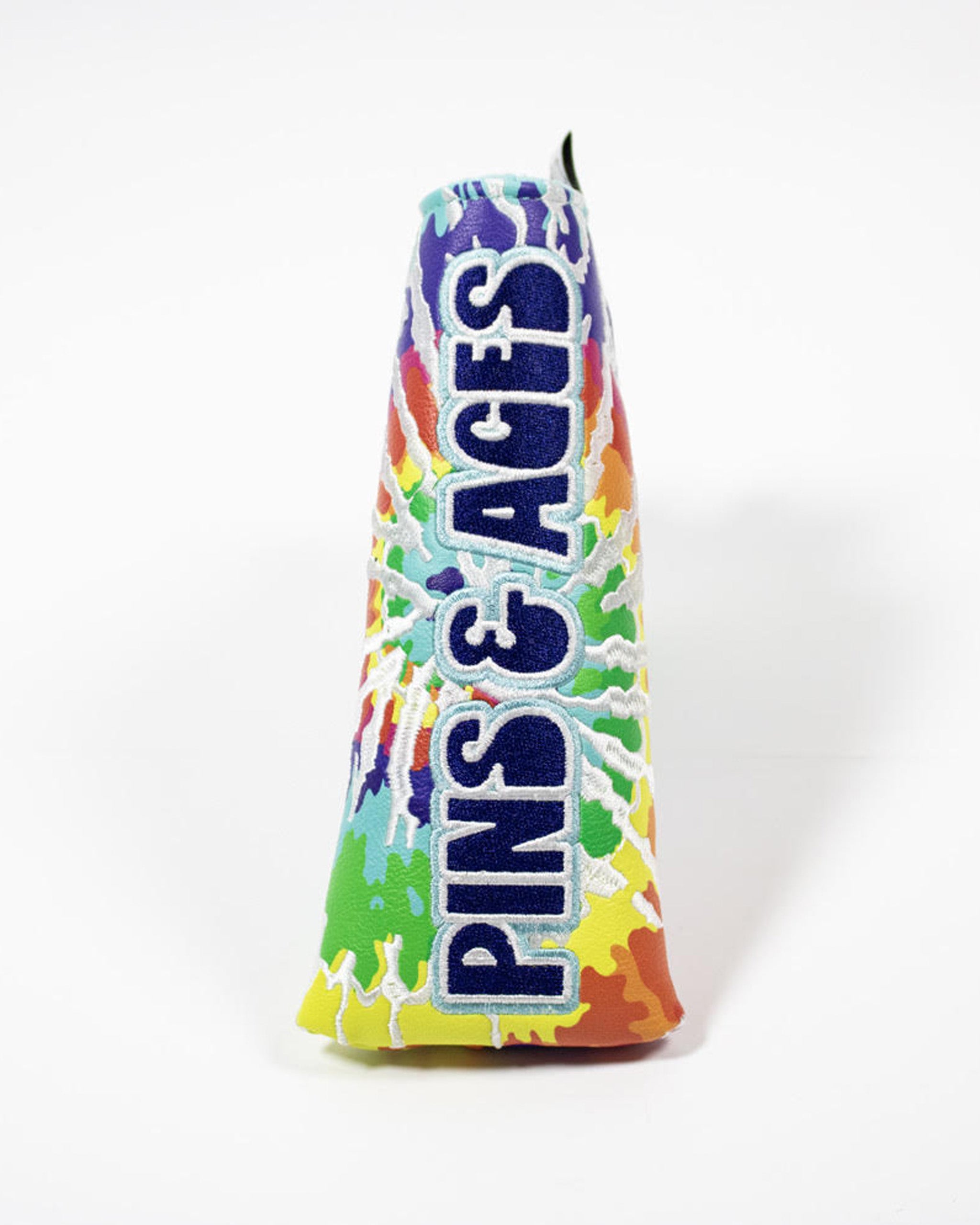 Colorful blade putter cover featuring a vibrant tie-dye design and bold "Pins & Aces" branding for stylish golf protection.