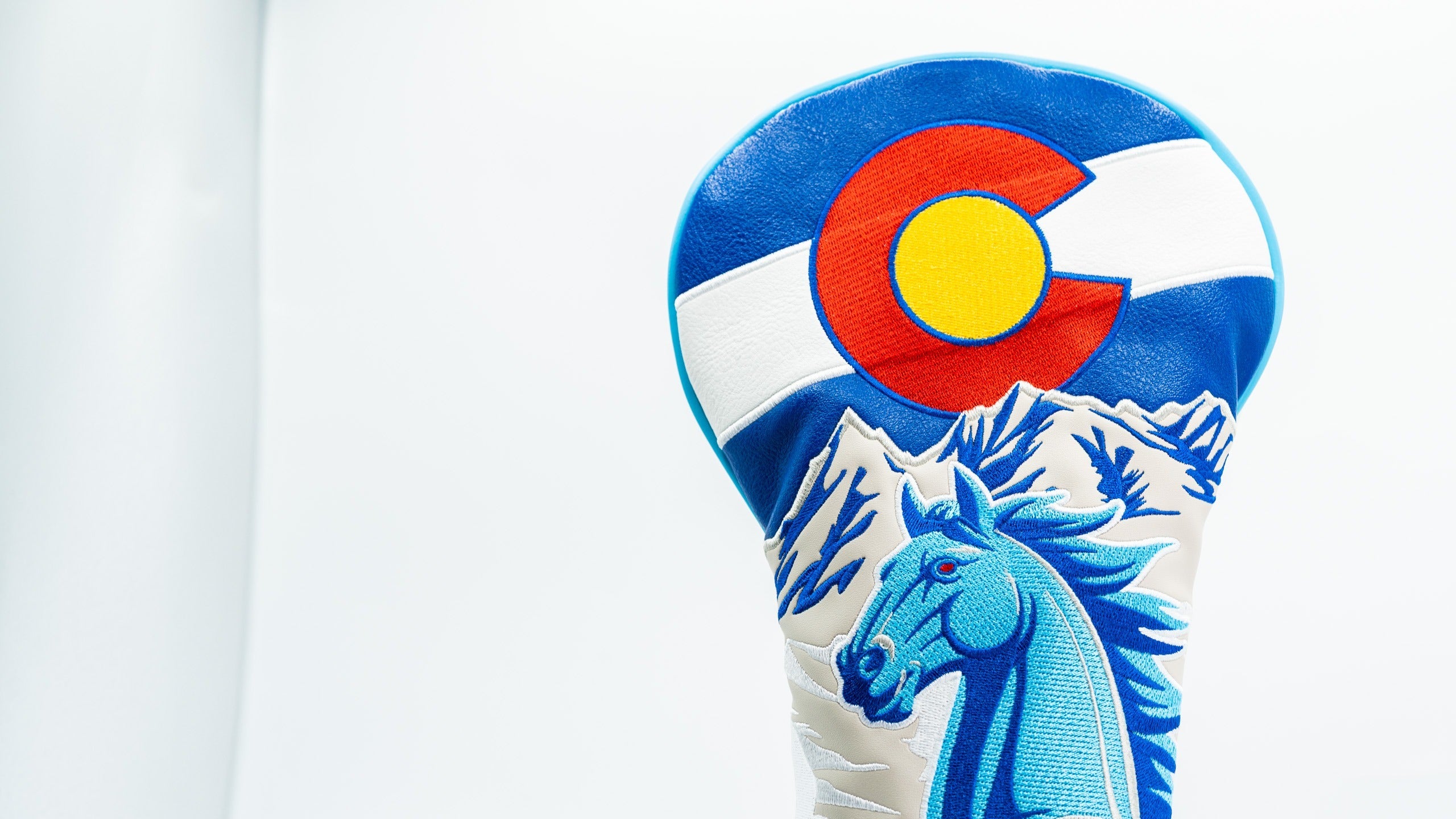 Bold Blucifer driver cover featuring a blue horse design and Colorado state flag colors, perfect for standout golf style.