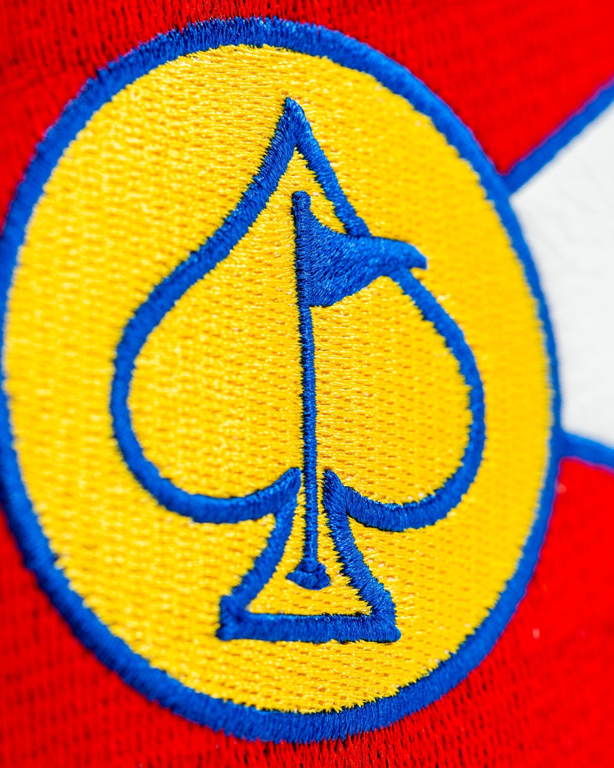 Bold driver cover featuring a vibrant yellow and blue spade emblem, perfect for golfers looking to stand out on the course.