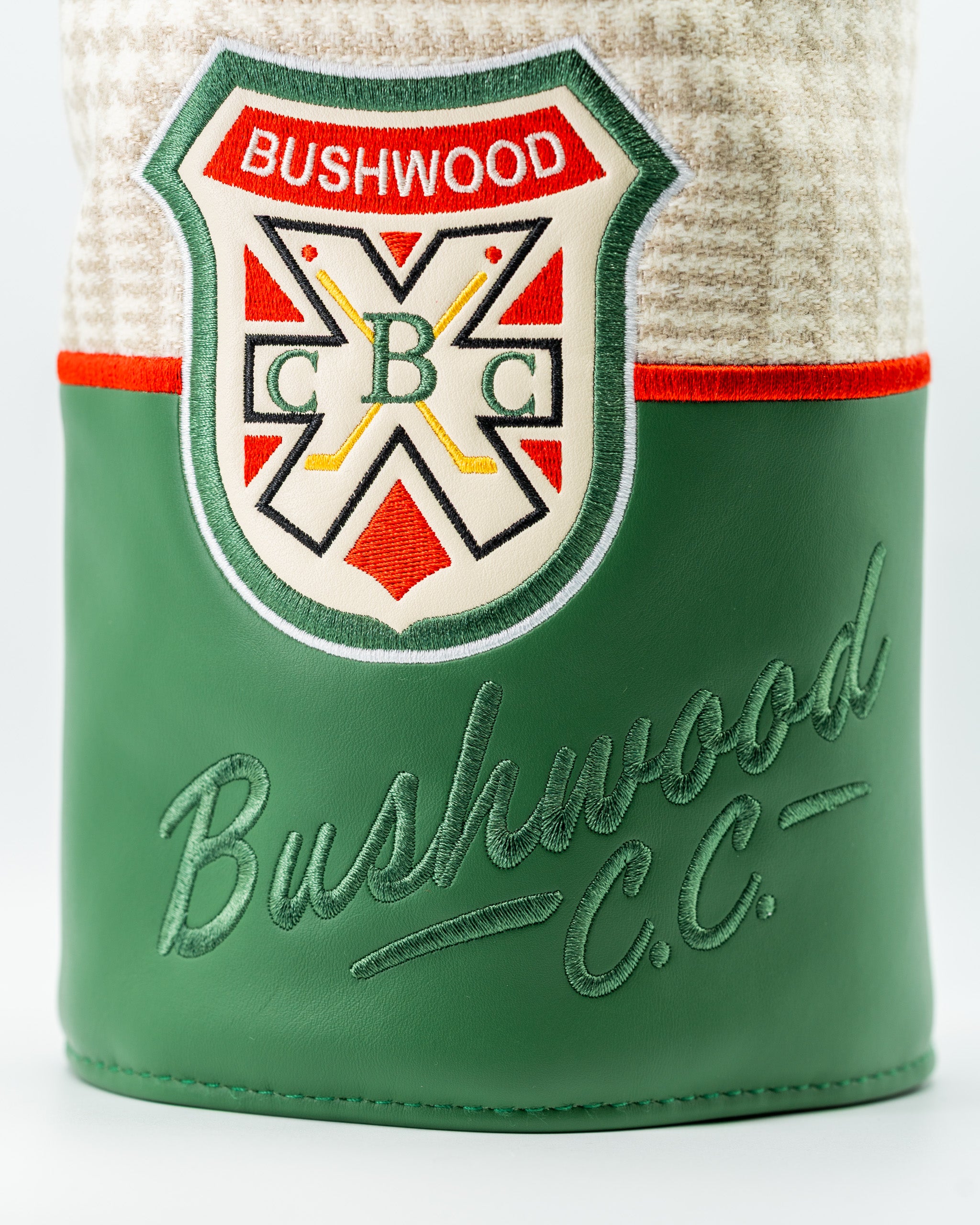 Bushwood CC driver cover featuring a classic design with a green leather base and embroidered logo for stylish golf protection.