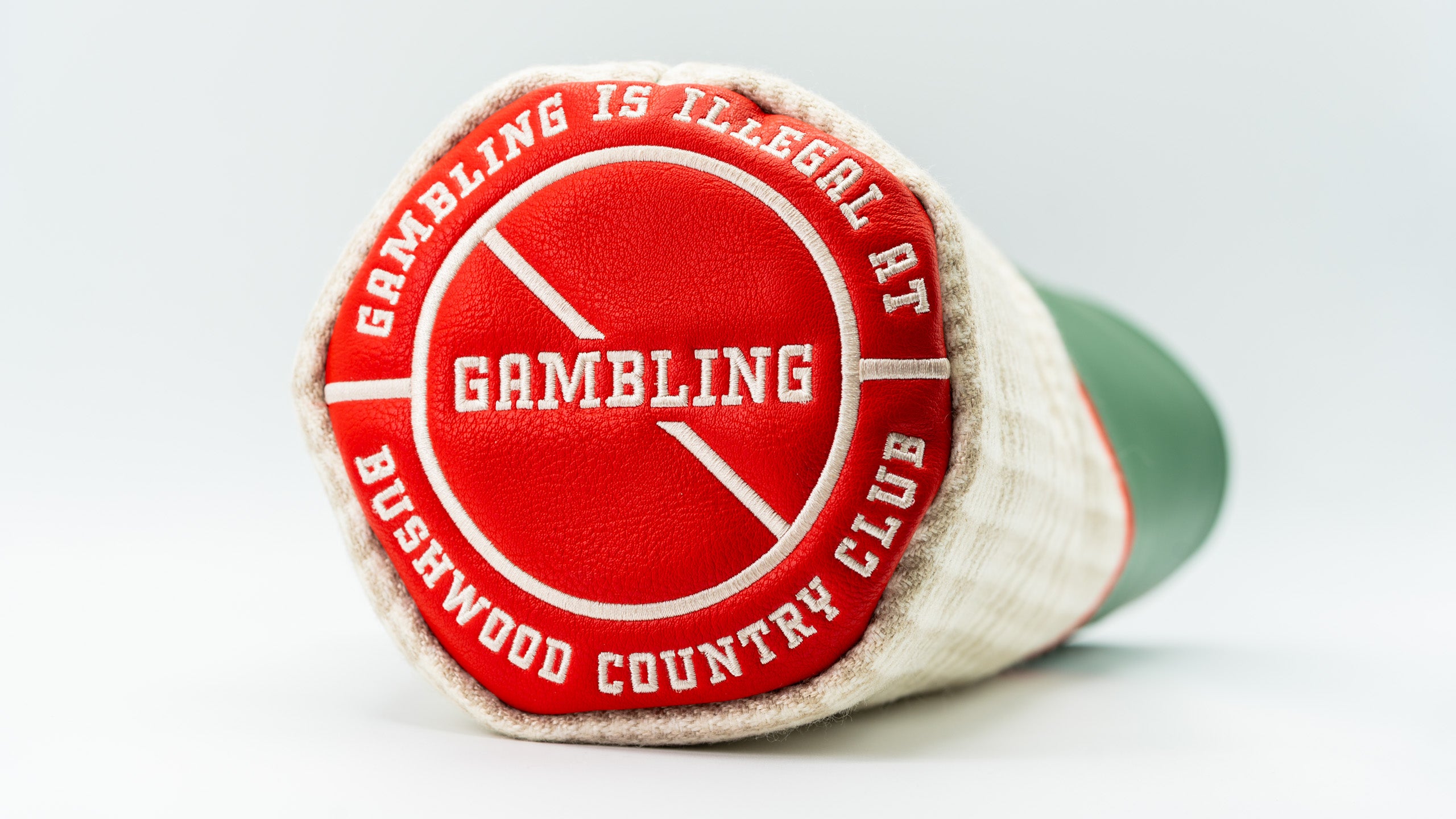 Bold Bushwood Country Club driver cover featuring a red and white design with the phrase "Gambling is illegal at Bushwood.