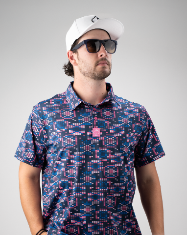Bold Tetrafloral Dark golf polo featuring a vibrant geometric pattern, paired with sunglasses and a white cap.