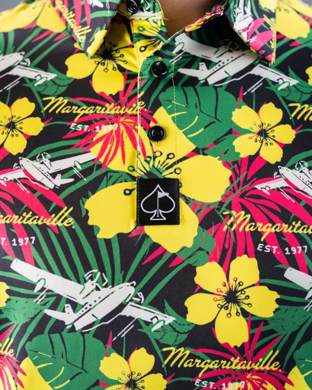 Bold Margaritaville Daydreamin' golf shirt featuring vibrant floral patterns and a unique airplane design.