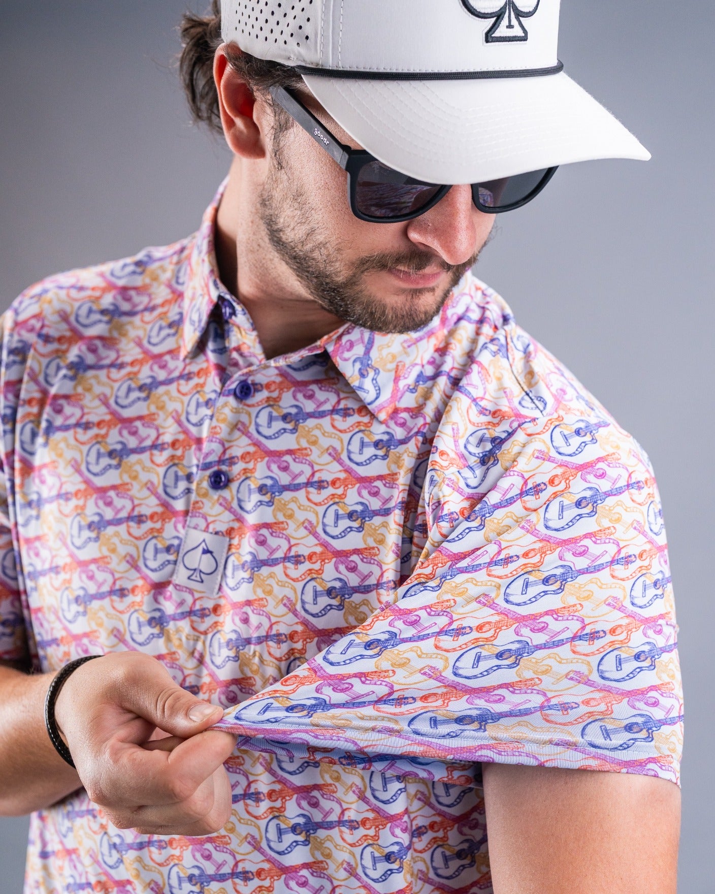 Stylish man showcasing a vibrant Margaritaville shirt featuring colorful guitar and tropical designs, perfect for casual outings.