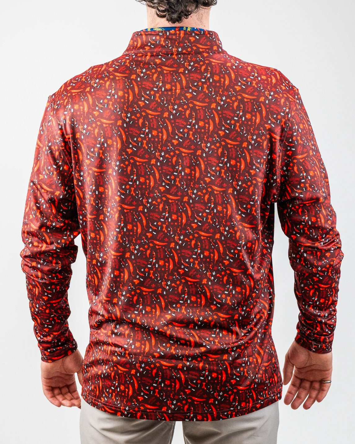 Bold red golf jacket with orange chili pepper and "Louisiana" print, perfect for stand-out golf style.