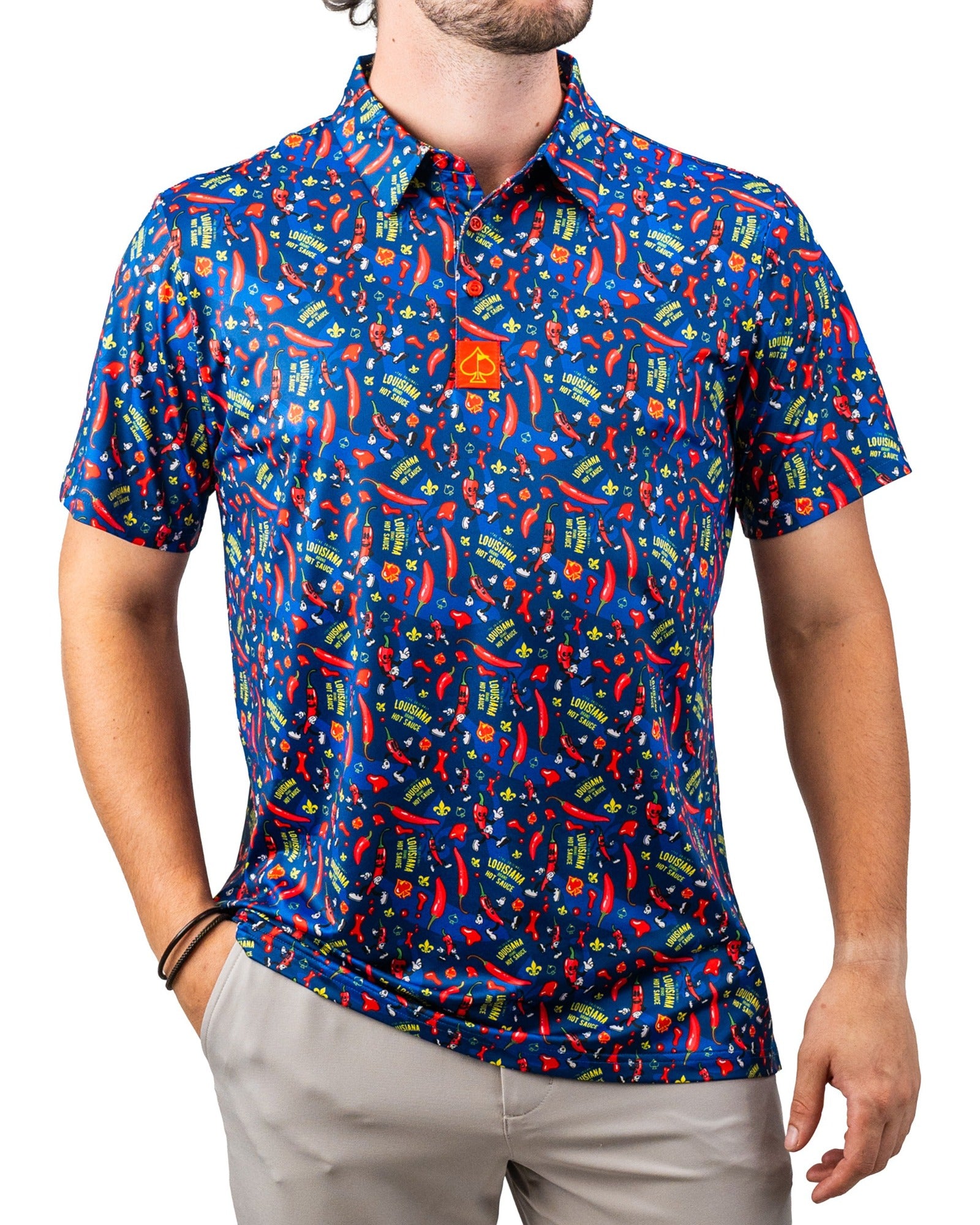 Bright blue golf shirt with red chili pepper, hot sauce, and Louisiana-themed graphics, perfect for bold golf style.