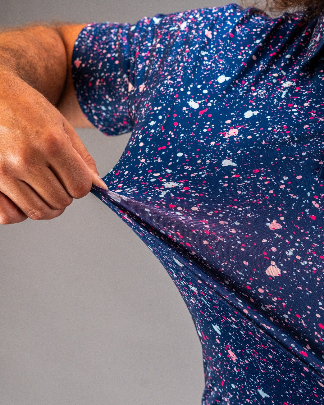 Bold blue splatter golf shirt showcasing vibrant colors and stretchy fabric, perfect for golfers who want to stand out.