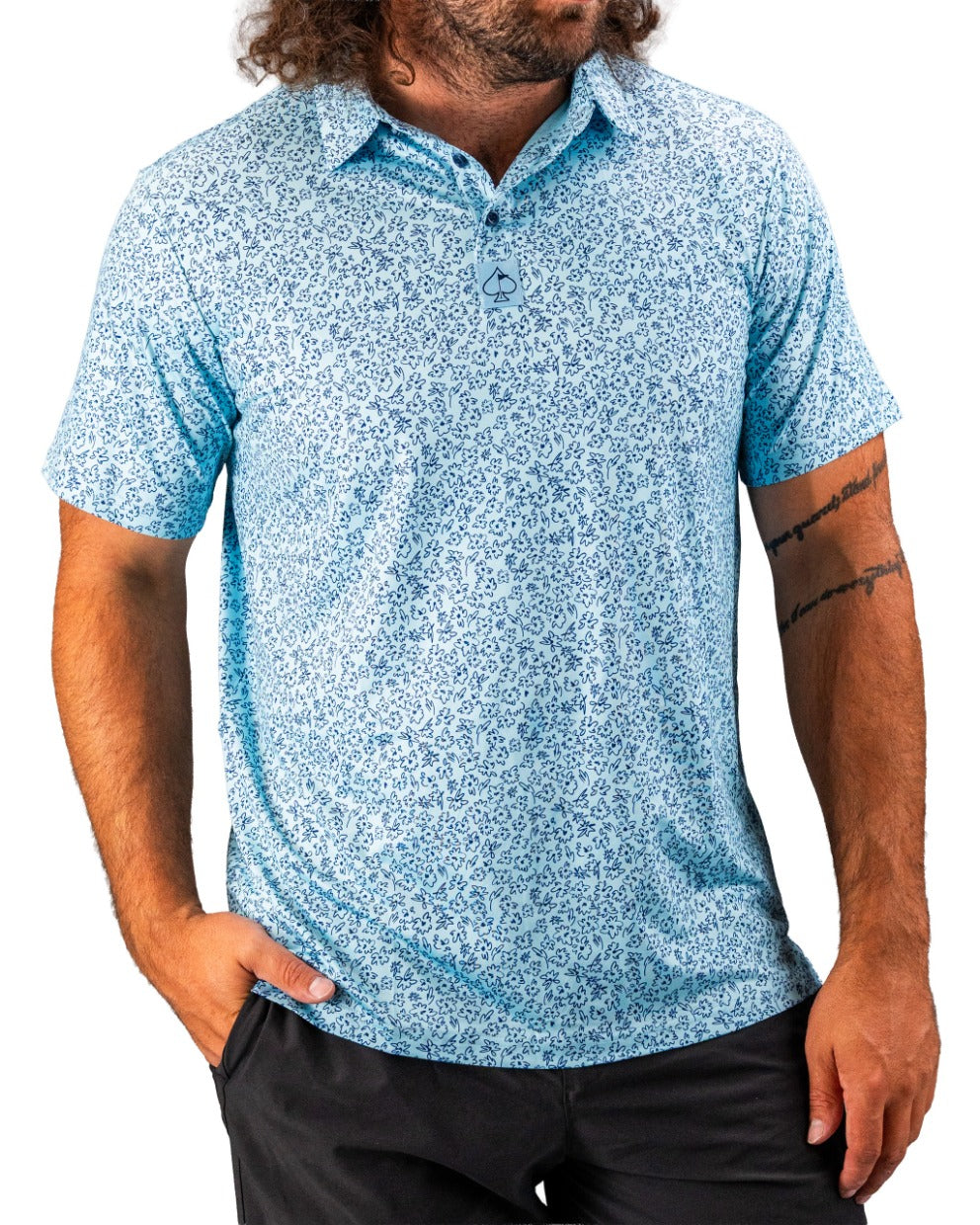 Men's short-sleeve golf shirt in light blue featuring a floral doodle pattern, perfect for a stylish day on the course.