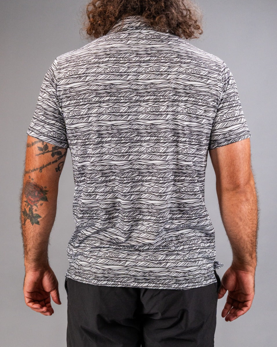 Men's Fragment Black golf shirt featuring a bold, abstract pattern in black and white, designed for standout style on the course.