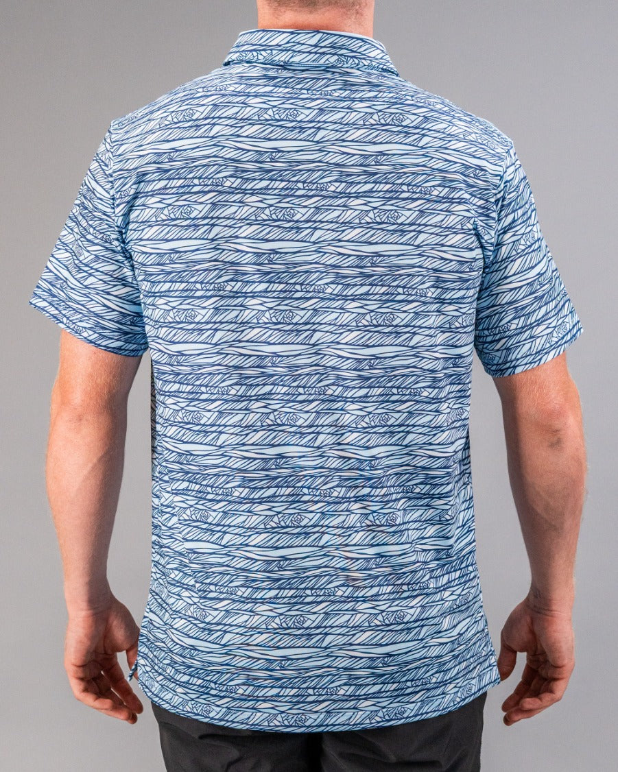 Men's Fragment Blue golf shirt featuring a unique wave pattern in shades of blue, designed for a bold look on the course.