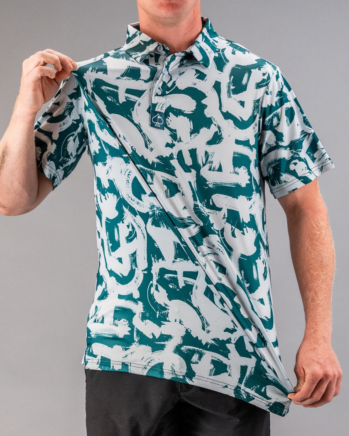 Bold golf polo featuring a dynamic paint stroke pattern in green and white, perfect for stylish golfers on the course.