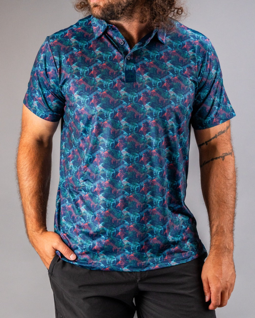 Bold golf polo featuring a vibrant swordfish pattern in shades of blue and pink, perfect for making a statement on the course.