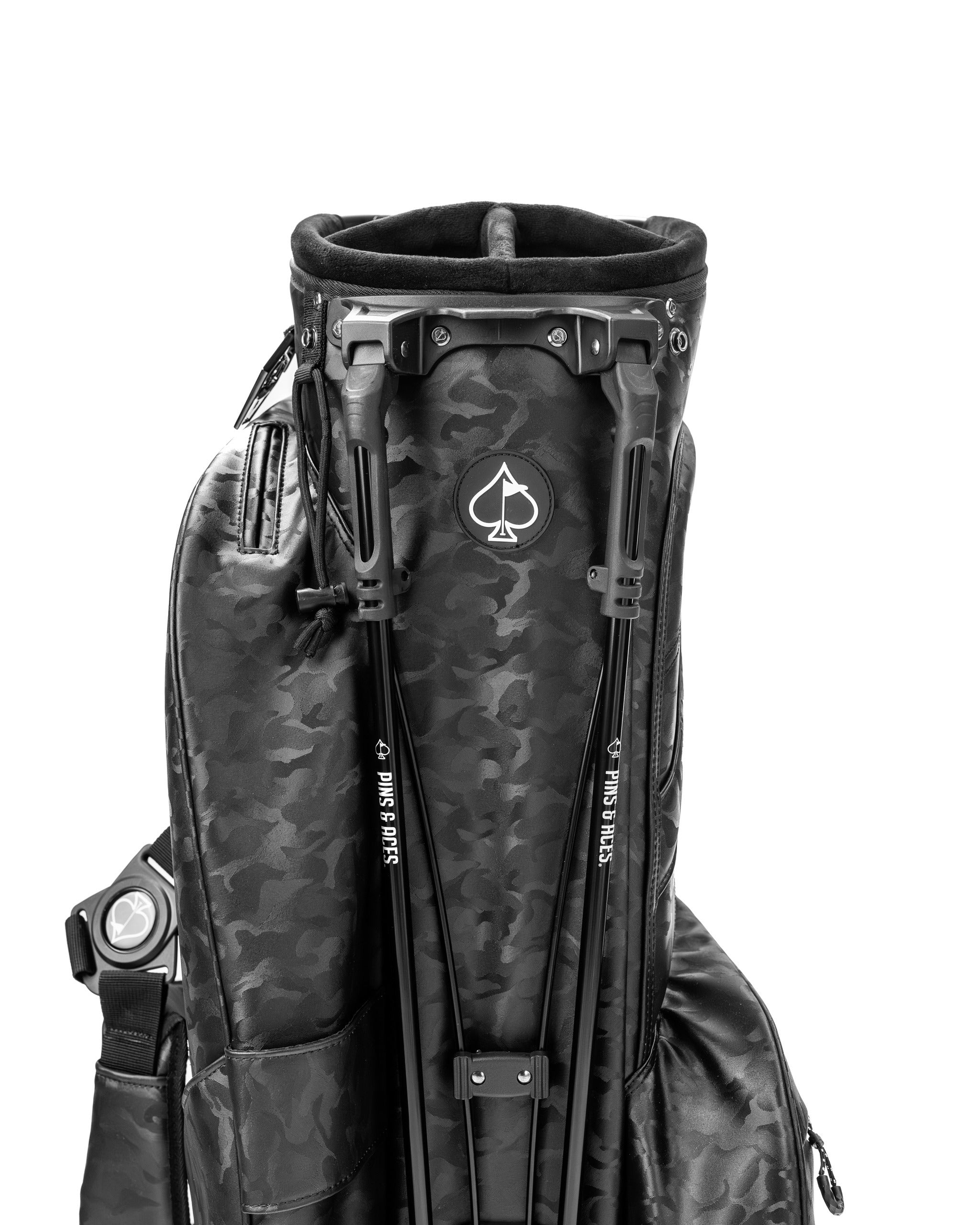 Black camo golf bag featuring a sleek design and multiple pockets for accessories, ideal for stylish golfers.
