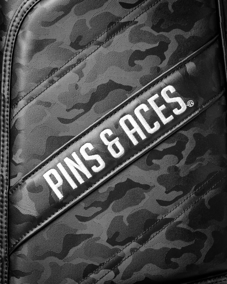 Black camo golf bag featuring the Pins & Aces logo, designed for golfers seeking style and functionality on the course.