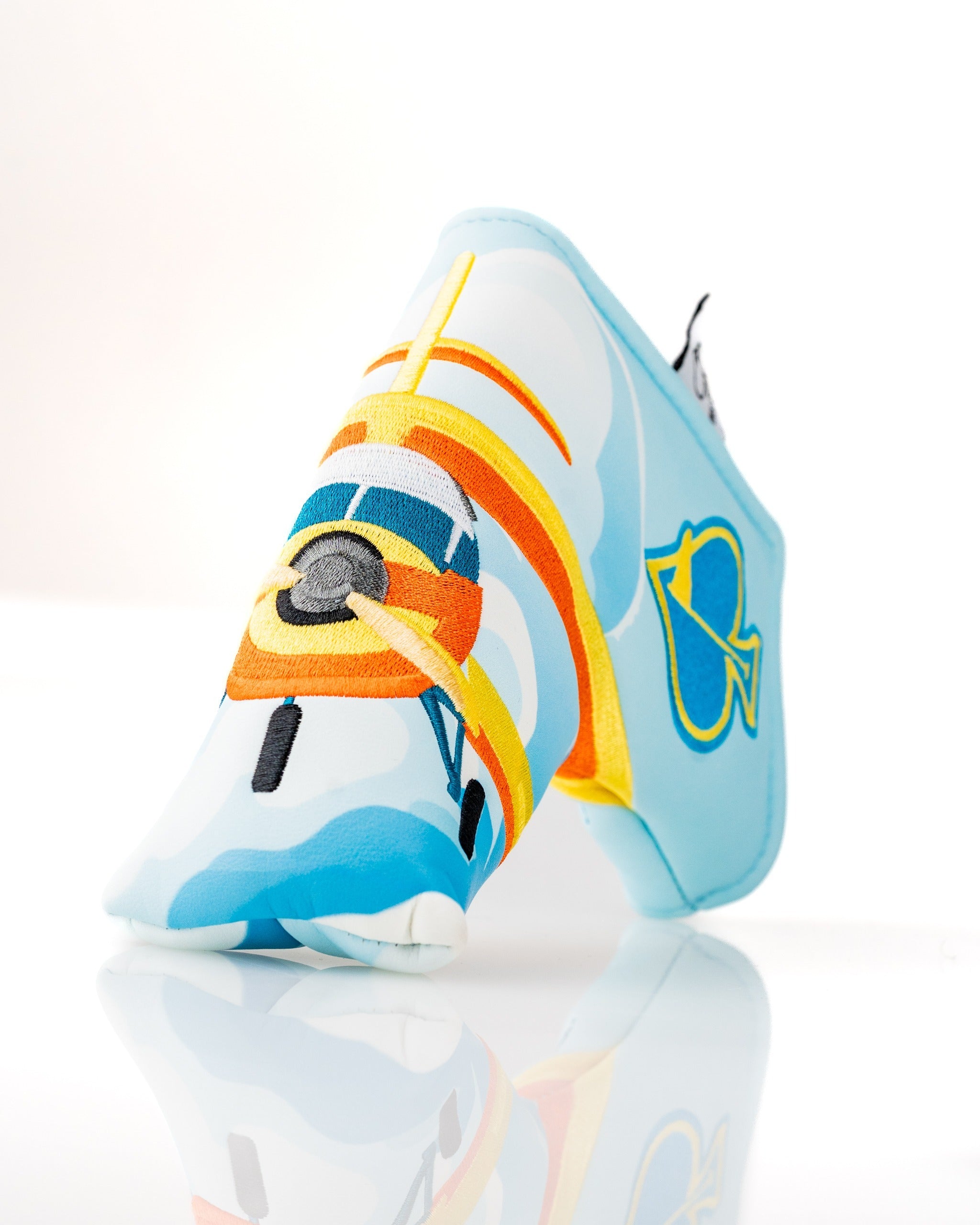 Brightly colored Margaritaville Puddle Jumper blade putter cover featuring a playful airplane design against a blue background.