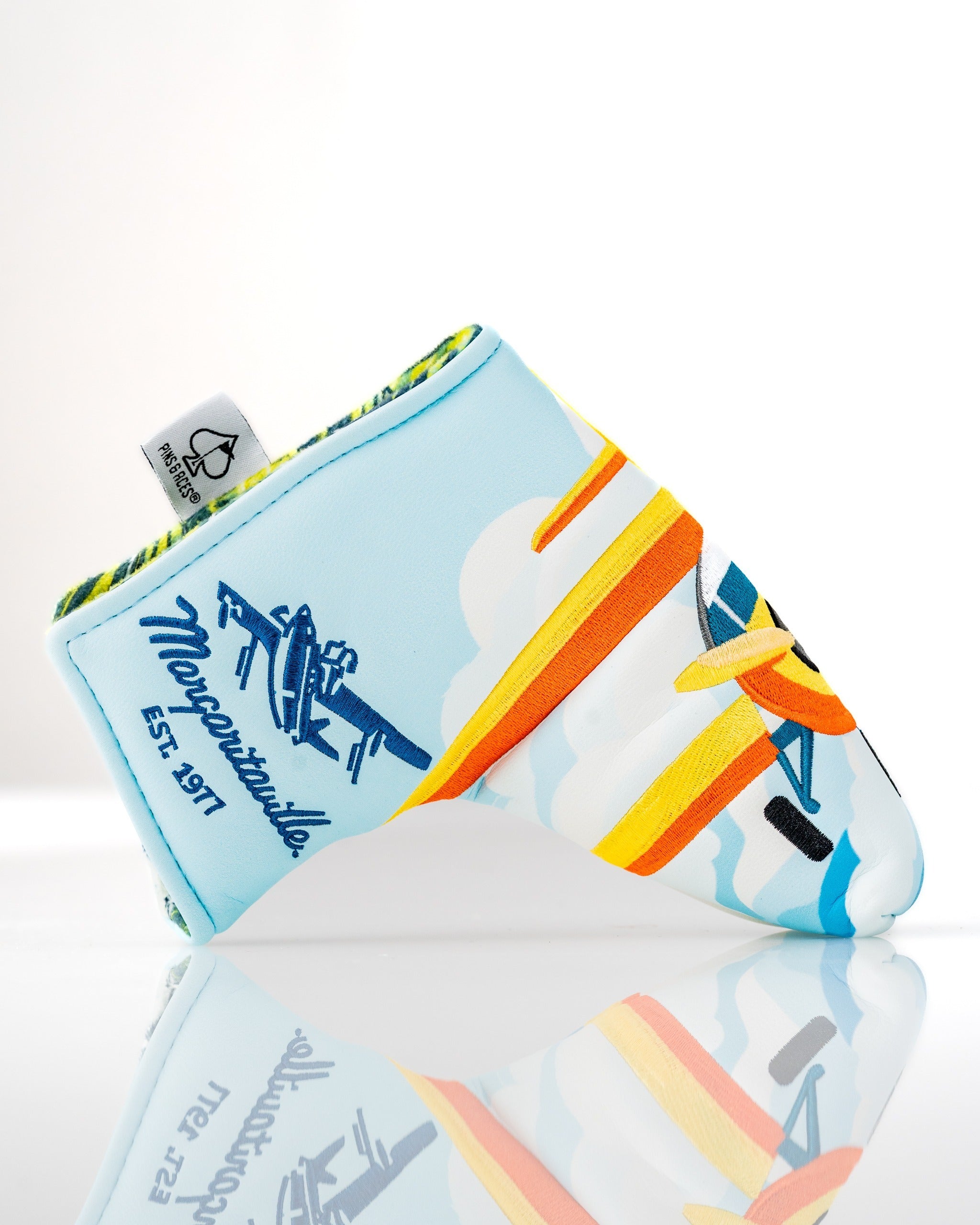 Colorful Margaritaville Puddle Jumper blade putter cover featuring a vibrant airplane design and retro branding.