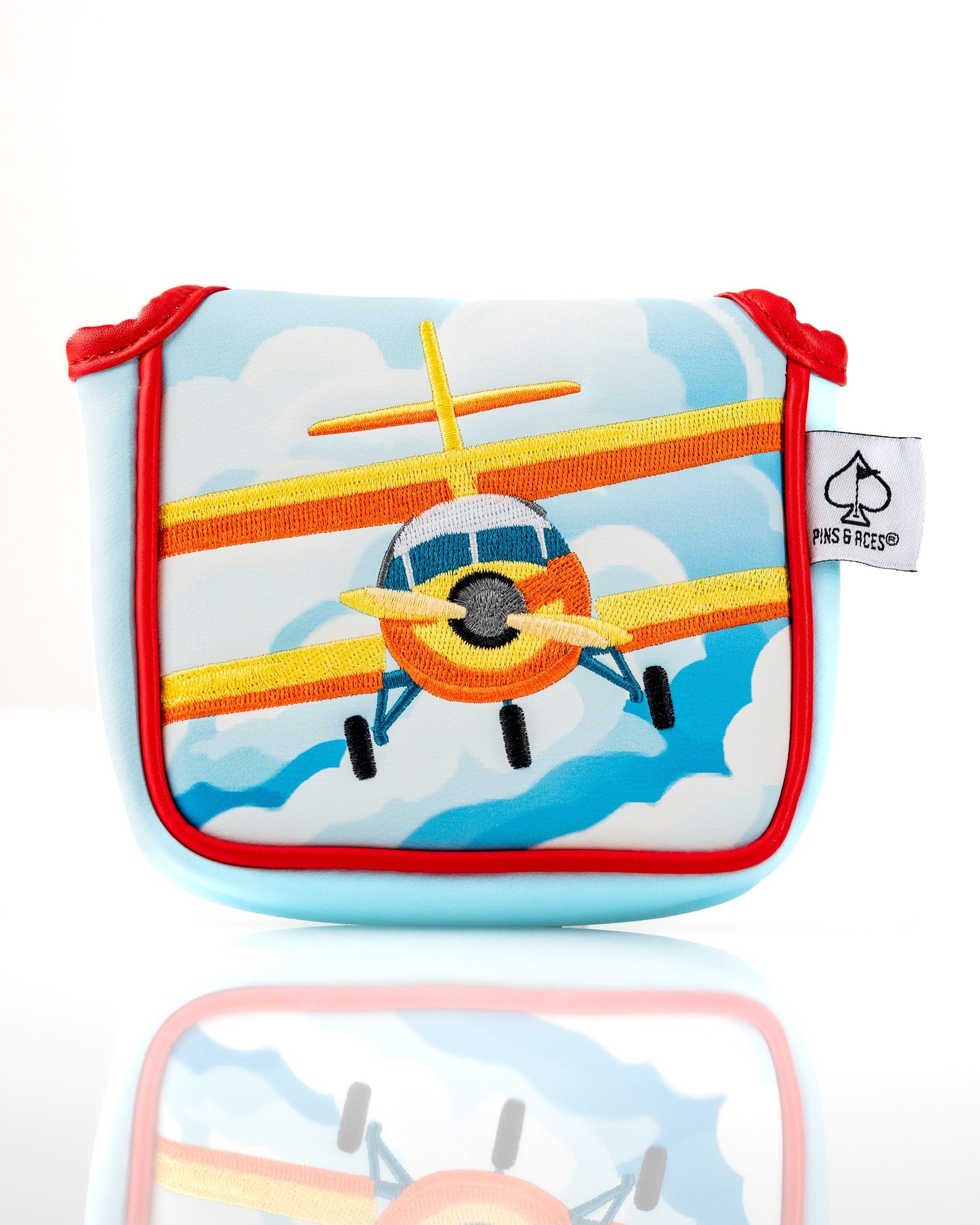 Colorful mallet putter cover featuring a vibrant airplane design against a blue sky with clouds, perfect for golf enthusiasts.