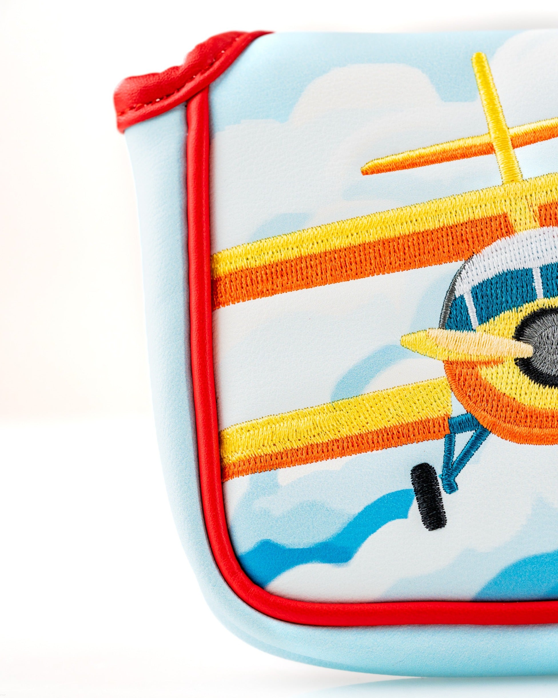 Colorful Margaritaville mallet putter cover featuring an embroidered airplane design against a blue sky background.