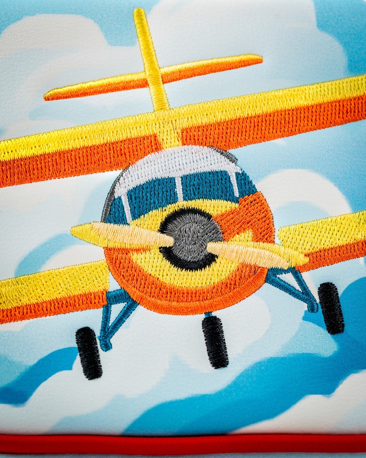 Colorful Margaritaville mallet putter cover featuring an embroidered airplane design against a blue sky background.