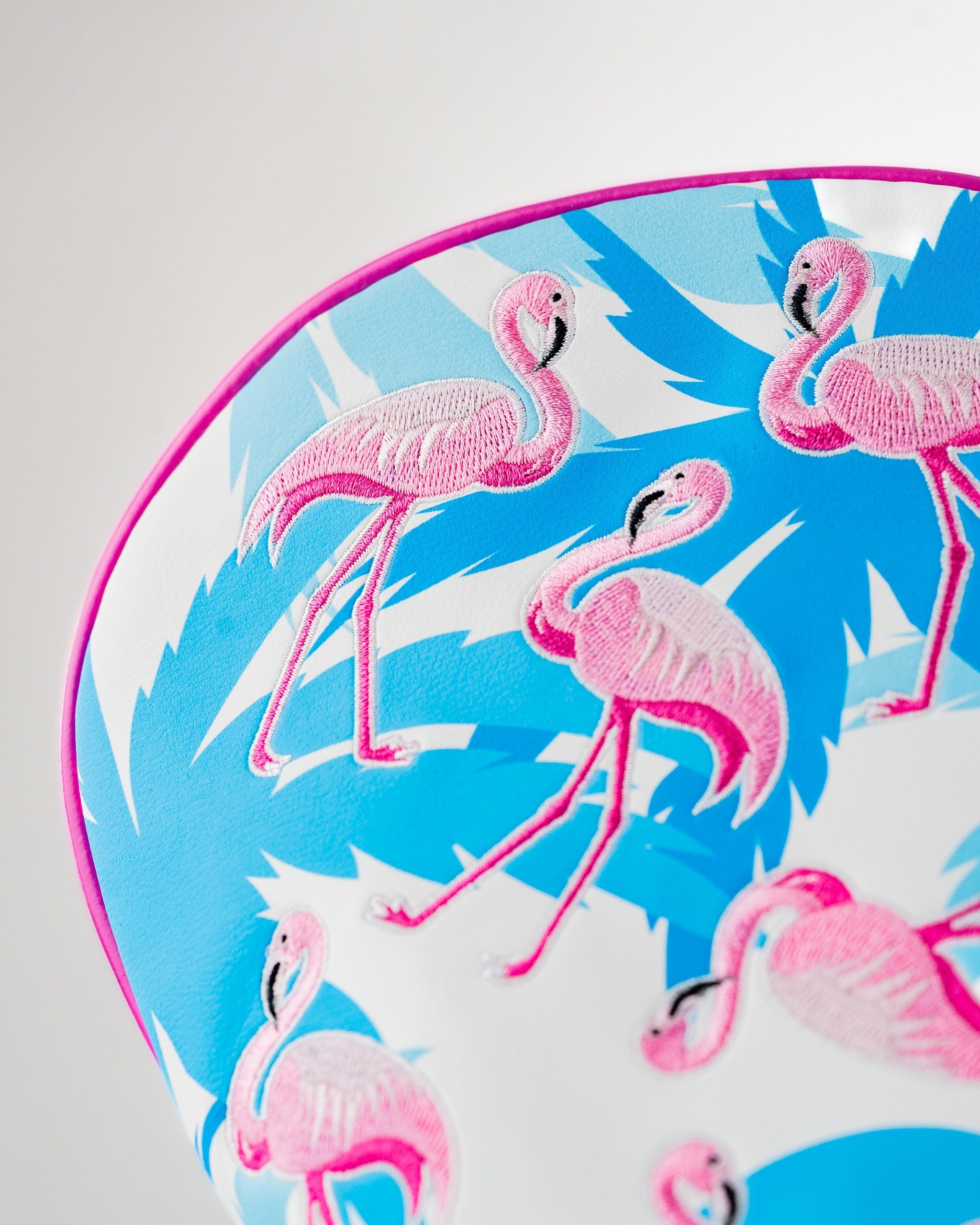 Vibrant driver cover featuring a colorful flamingo pattern on a blue background, perfect for stylish golfers.