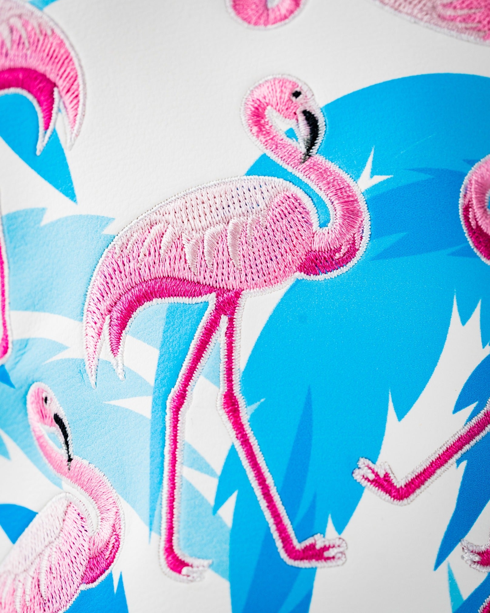 Vibrant driver cover featuring embroidered pink flamingos against a blue tropical background, perfect for stylish golfers.