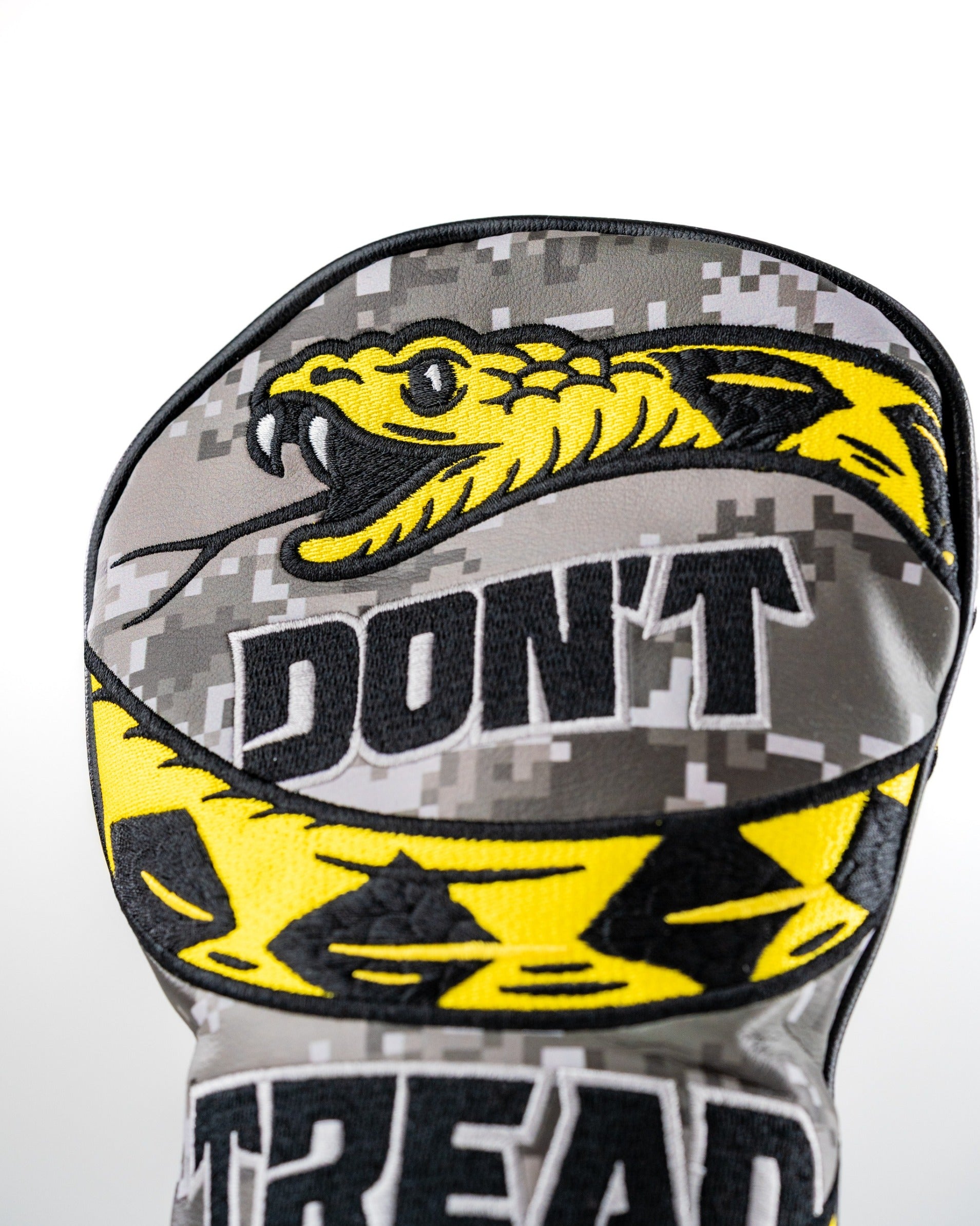 Camouflage fairway cover featuring a bold snake design and "Don't Tread On Me" text for standout golf style.