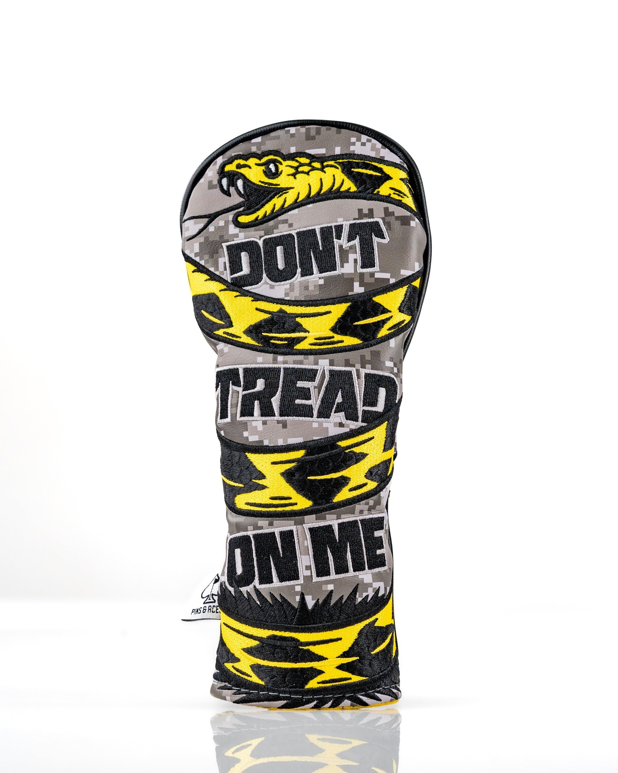 Bold hybrid golf cover featuring a camouflage design with "Don't Tread On Me" text and a striking yellow snake pattern.