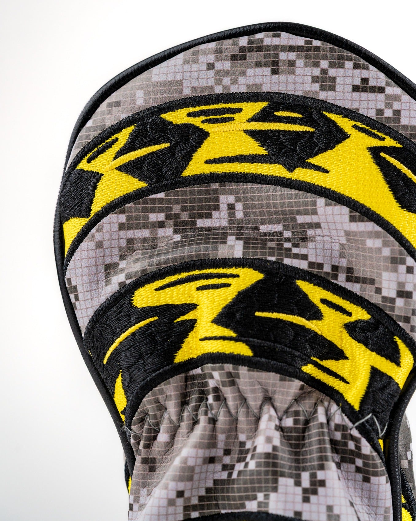 Bold hybrid golf cover featuring a camo design with striking yellow and black accents, perfect for standout golfers.