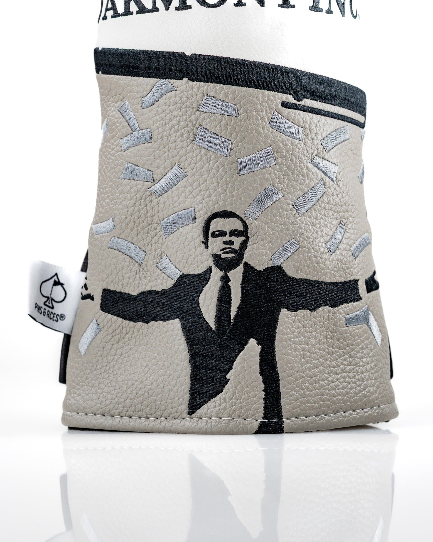 Stratton Oakmont driver cover featuring a bold design with a figure surrounded by money, perfect for standout golf style.