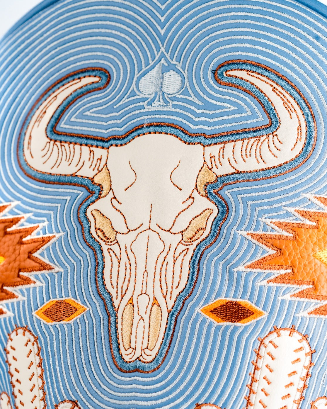 Western aesthetic driver cover featuring a detailed bull skull design with vibrant colors and intricate stitching.