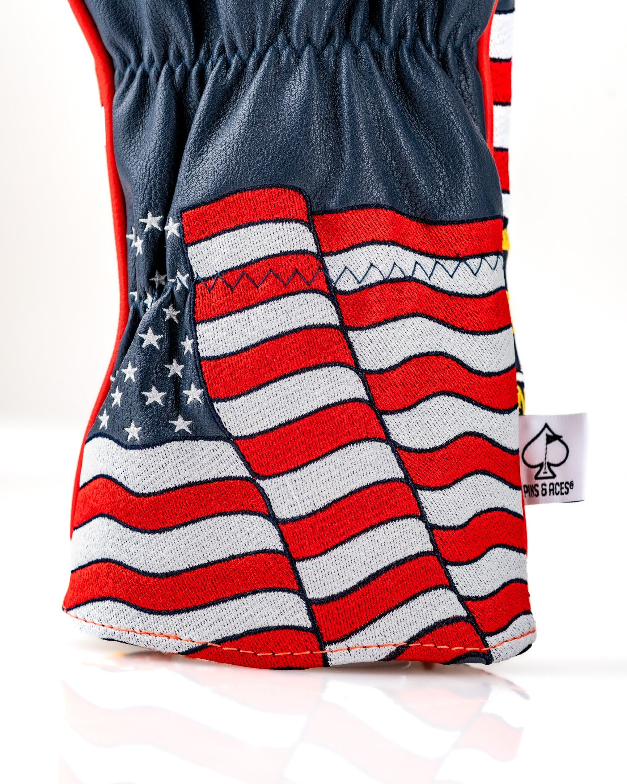 Bold driver cover featuring a vibrant design of the American flag with wavy stripes, perfect for patriotic golfers.