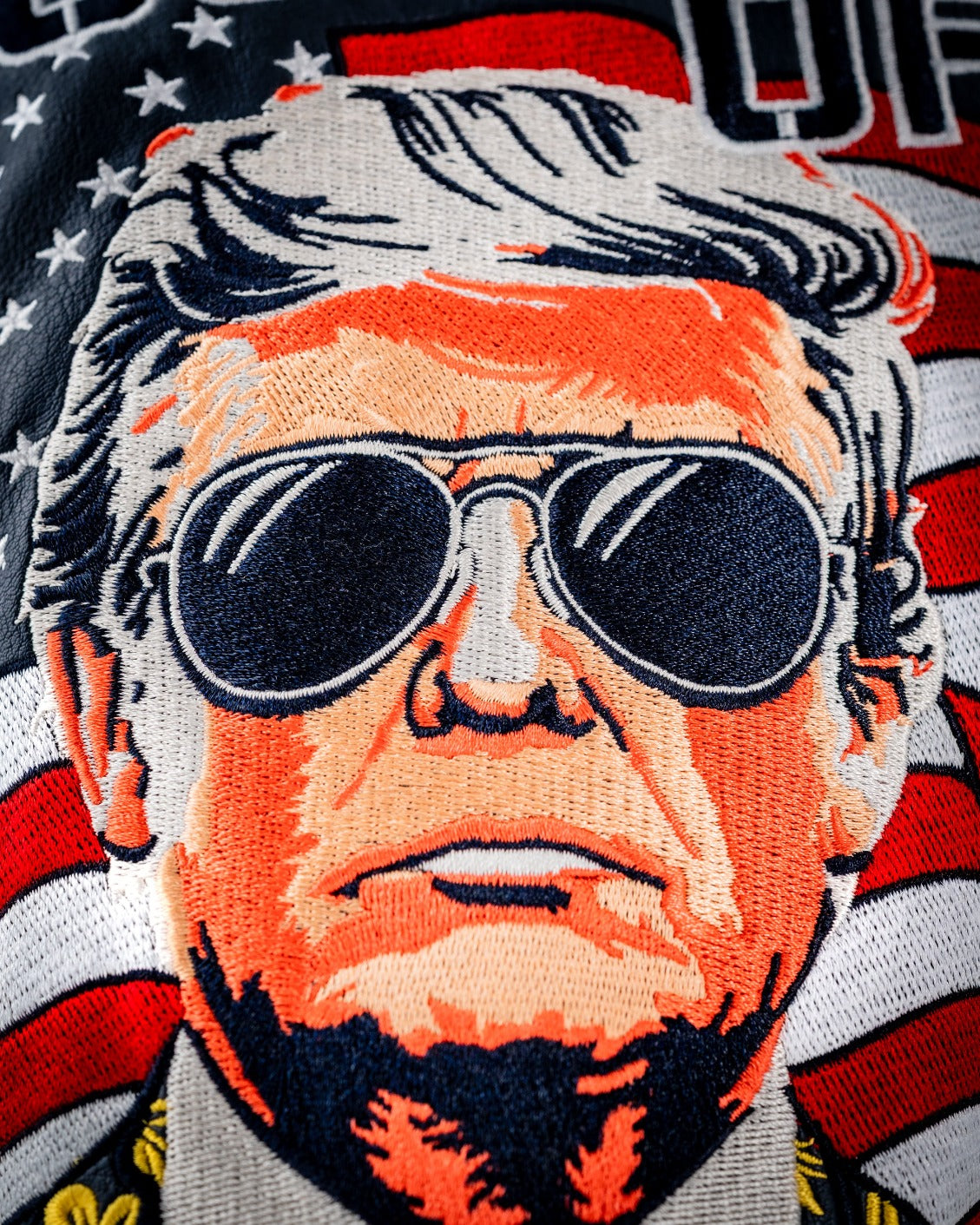 Bold driver cover featuring an embroidered design of a man with sunglasses, set against a backdrop of American flags.