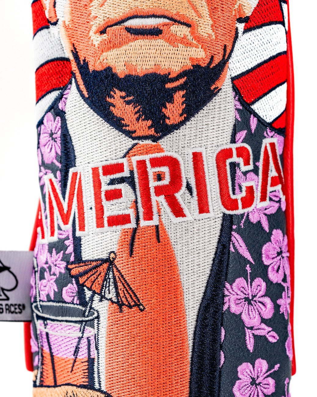 Bold golf fairway cover featuring a vibrant design with a caricature of a man holding a drink, adorned with tropical flowers and the word "America.
