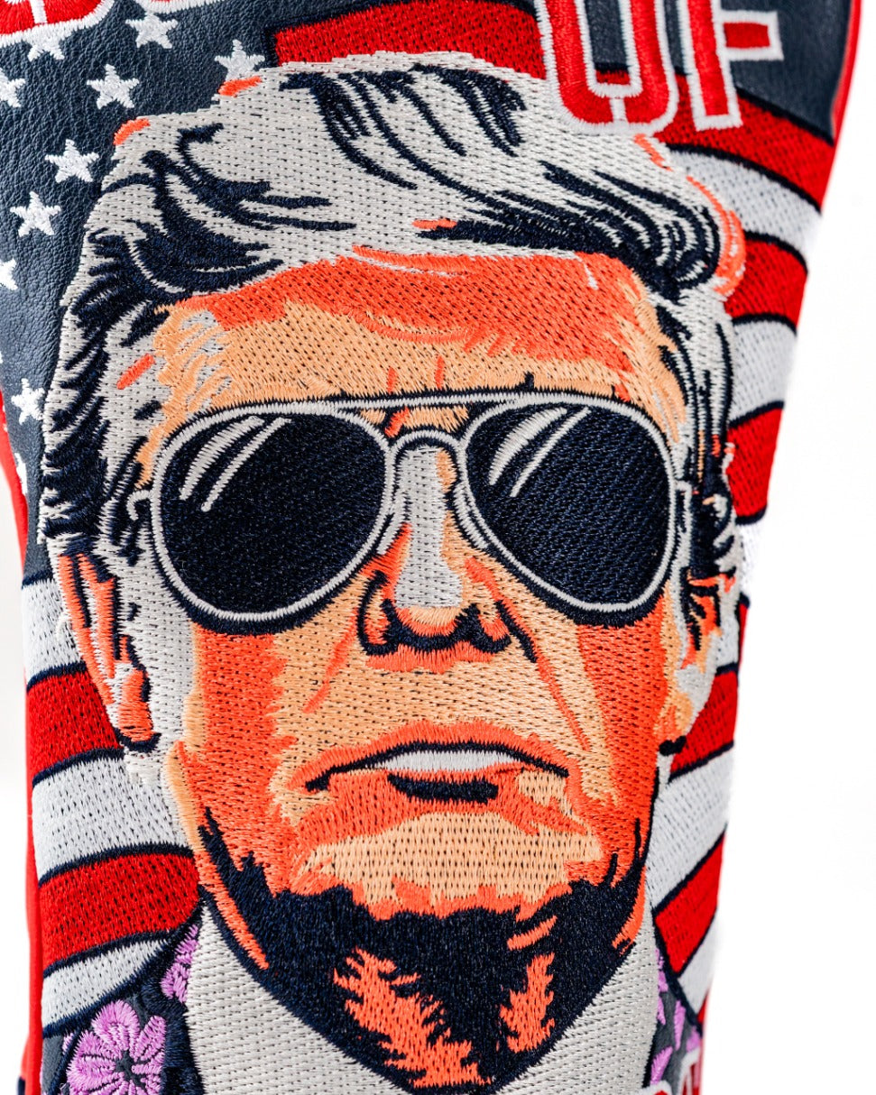 Bold golf fairway cover featuring a stylized portrait of a man in sunglasses against a backdrop of American flags.