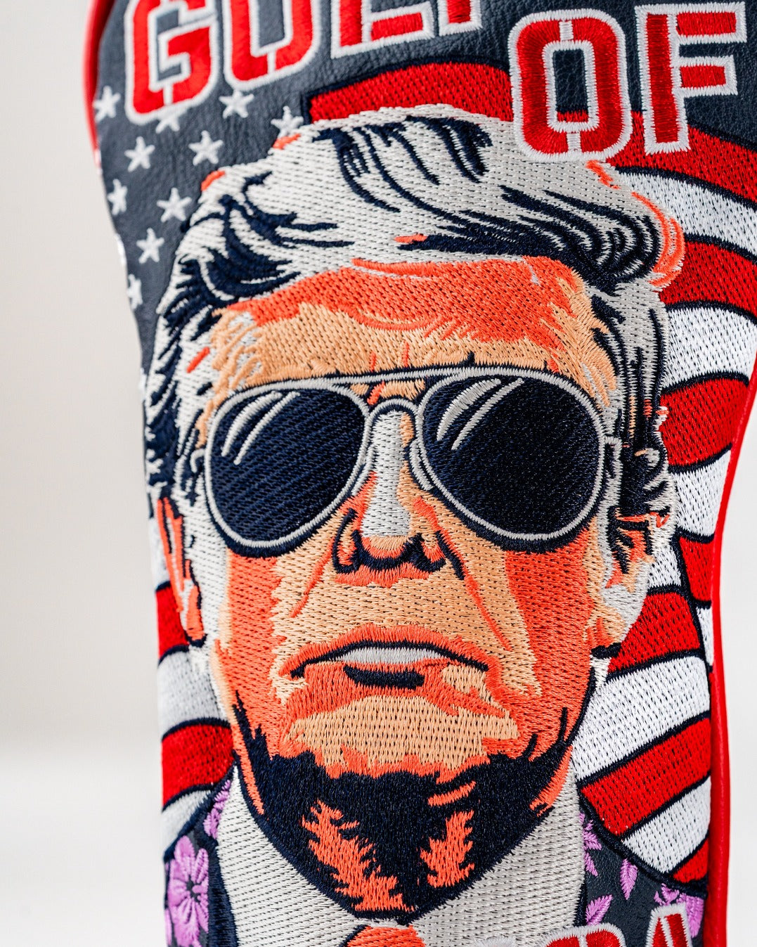 Bold golf fairway cover featuring a stylized portrait of a man in sunglasses against a patriotic background.