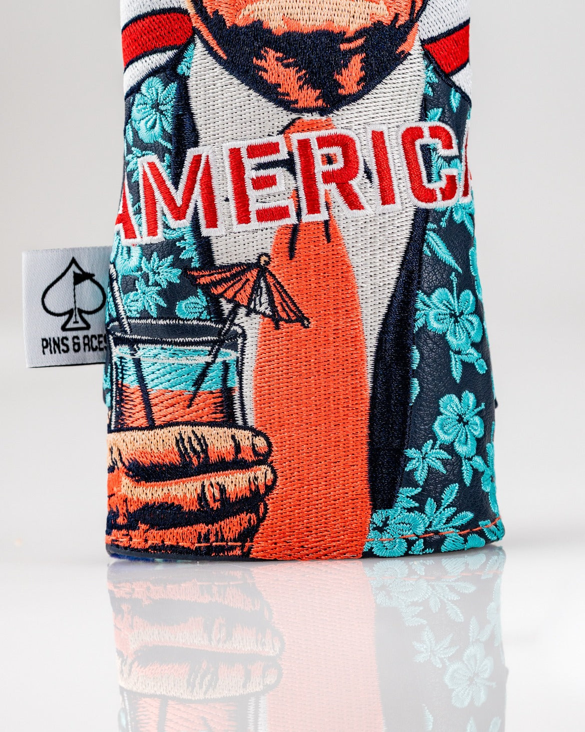 Bold hybrid golf headcover featuring a playful design of a suited figure holding a drink with "America" prominently displayed.