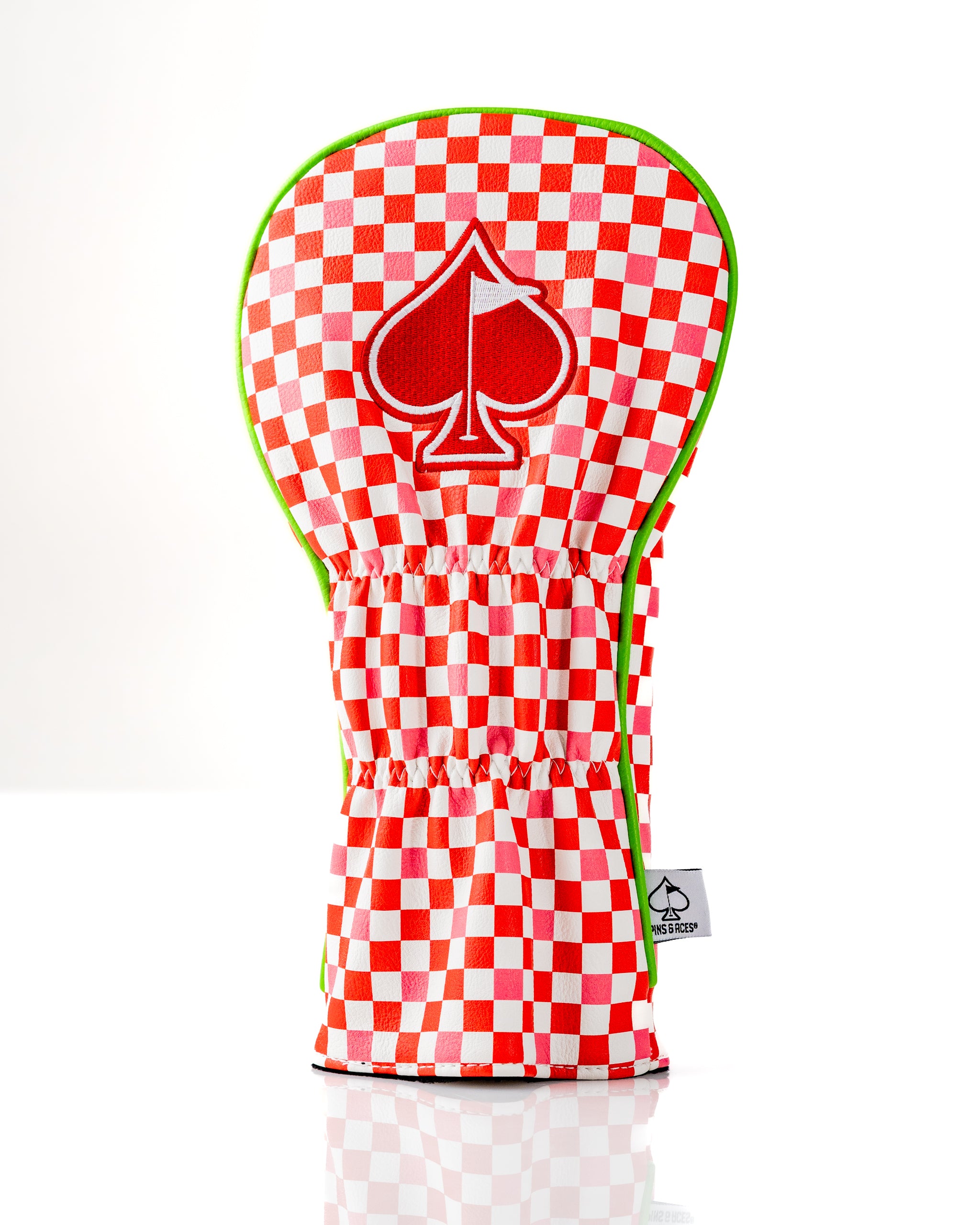 Bold red and white checkered driver cover featuring a spade logo, designed for golfers seeking unique style on the course.