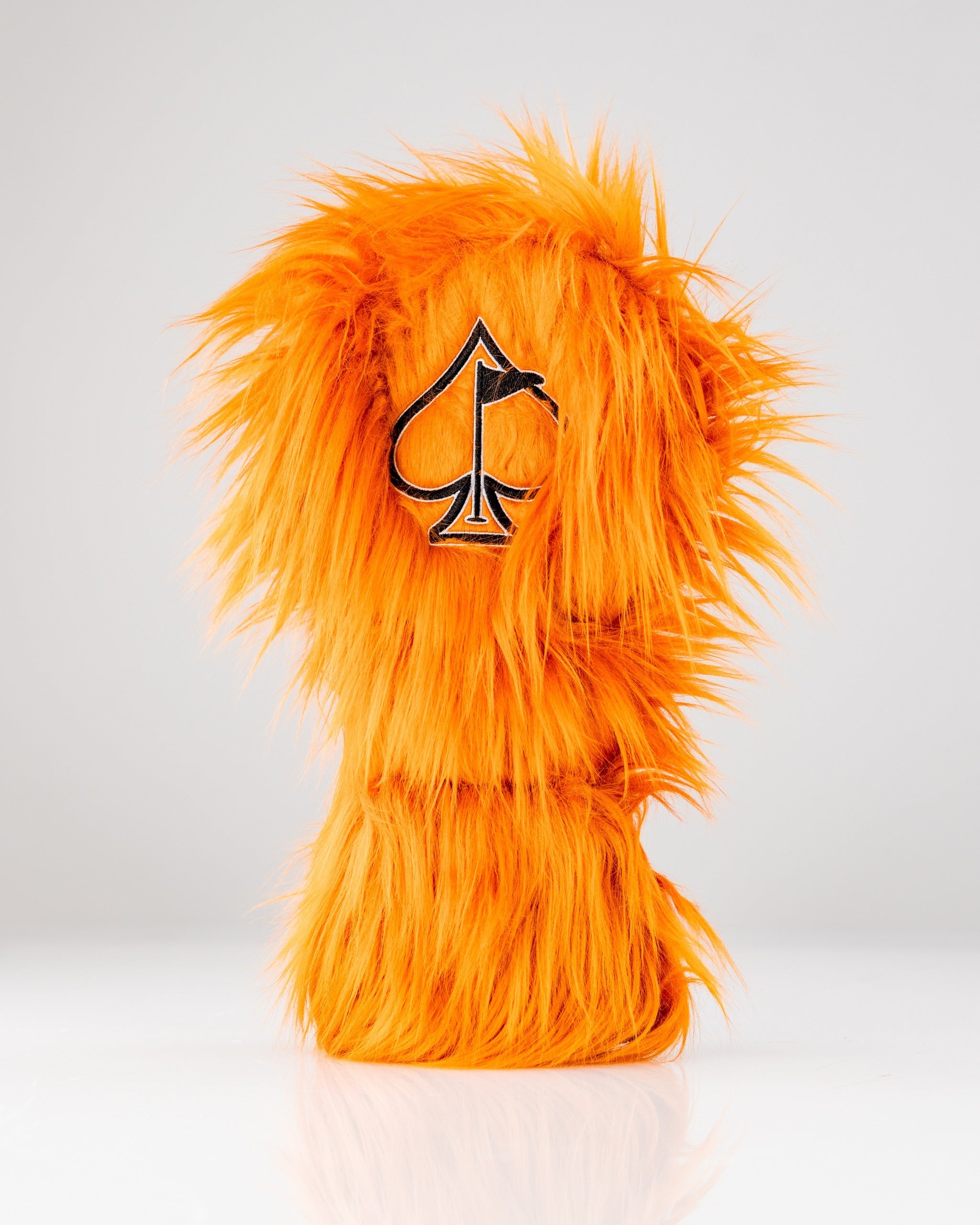 Bold orange furry driver cover featuring a spade logo, designed to make a statement on the golf course.