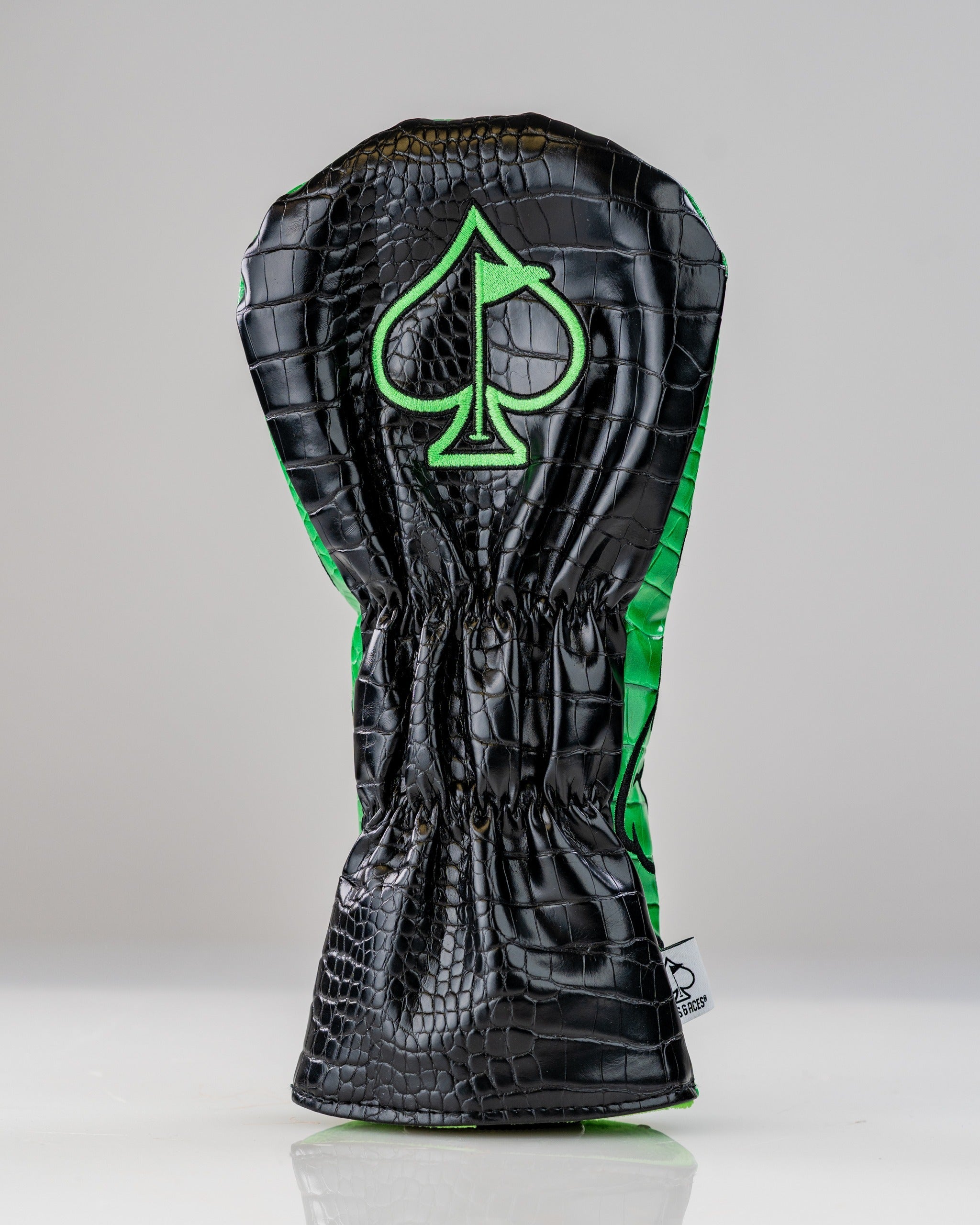 Bold T-Rex driver cover featuring a black and green crocodile texture with a spade logo, designed for standout golf style.