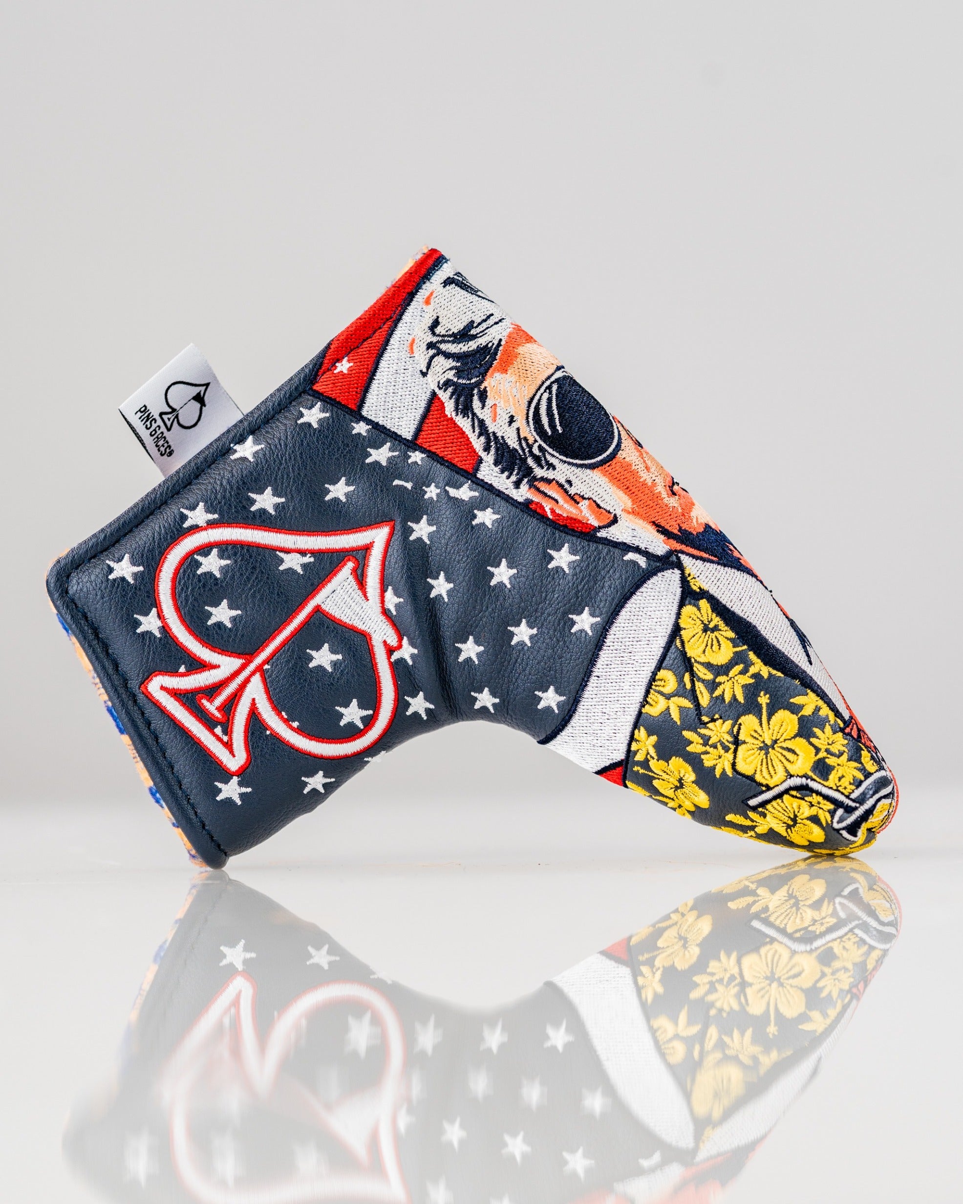 Bold golf blade cover featuring a colorful design with patriotic elements and floral accents, perfect for standout style on the course.
