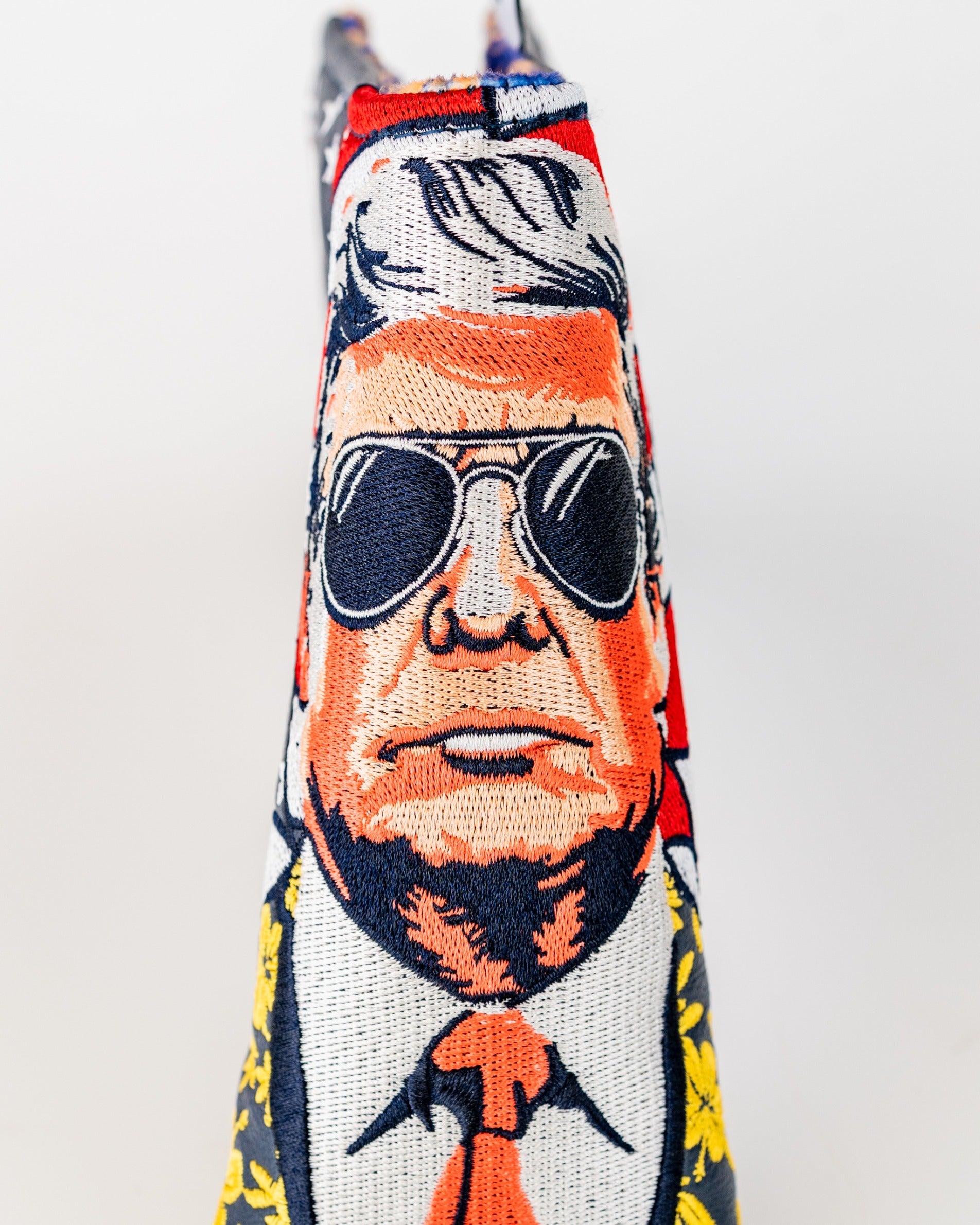 Bold golf blade cover featuring a caricature of a man in sunglasses and a suit, designed to stand out on the course.