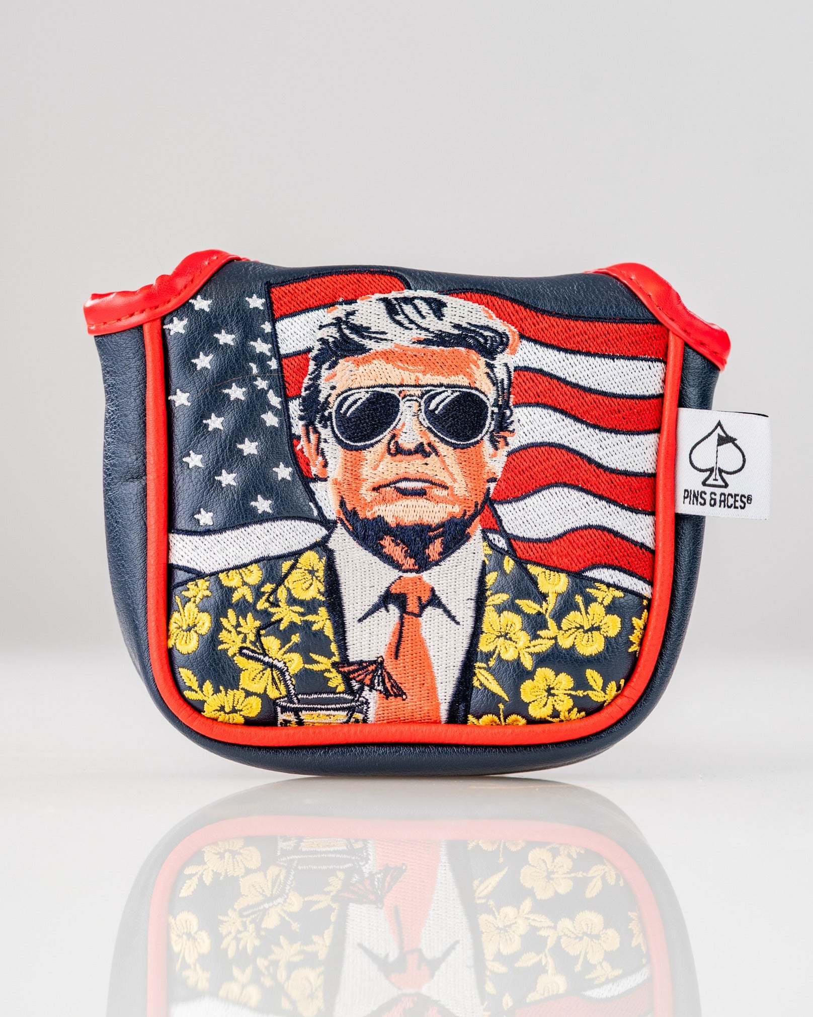 Bold mallet putter cover featuring a stylized illustration of a man in sunglasses with a floral suit against an American flag backdrop.